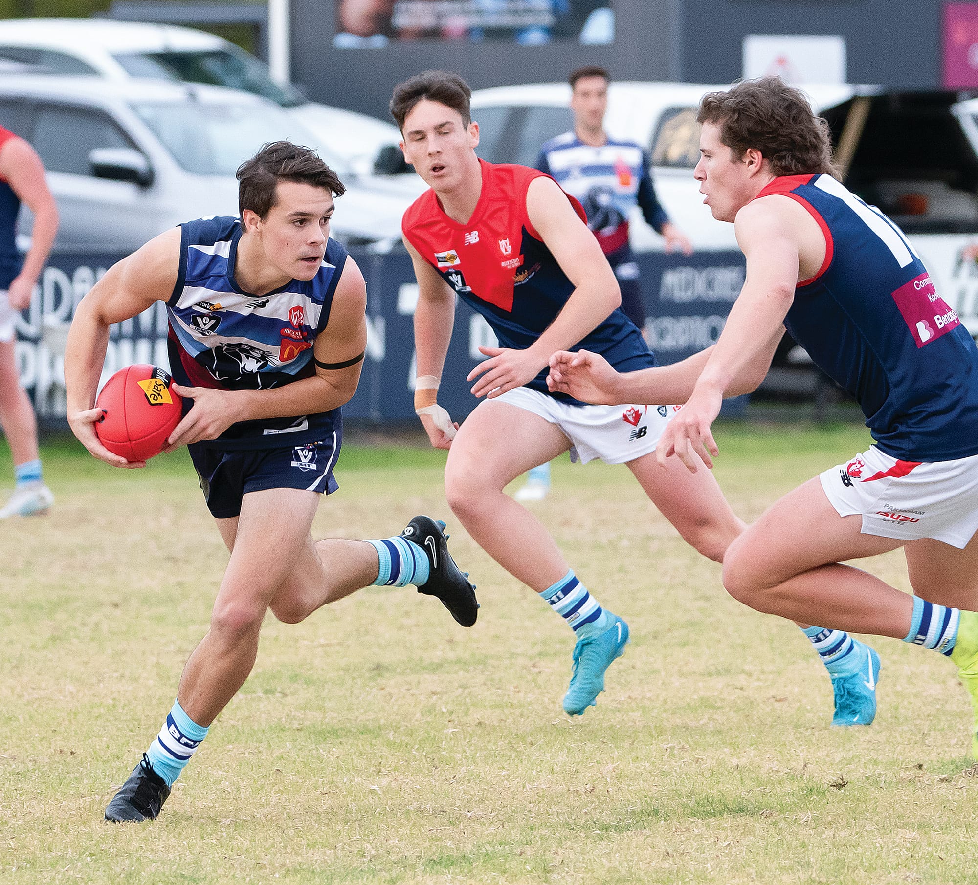 Trent Cartmel runs clear with the football as his Koo Wee Rup opponent closes in.  
Photos: Anna Carson