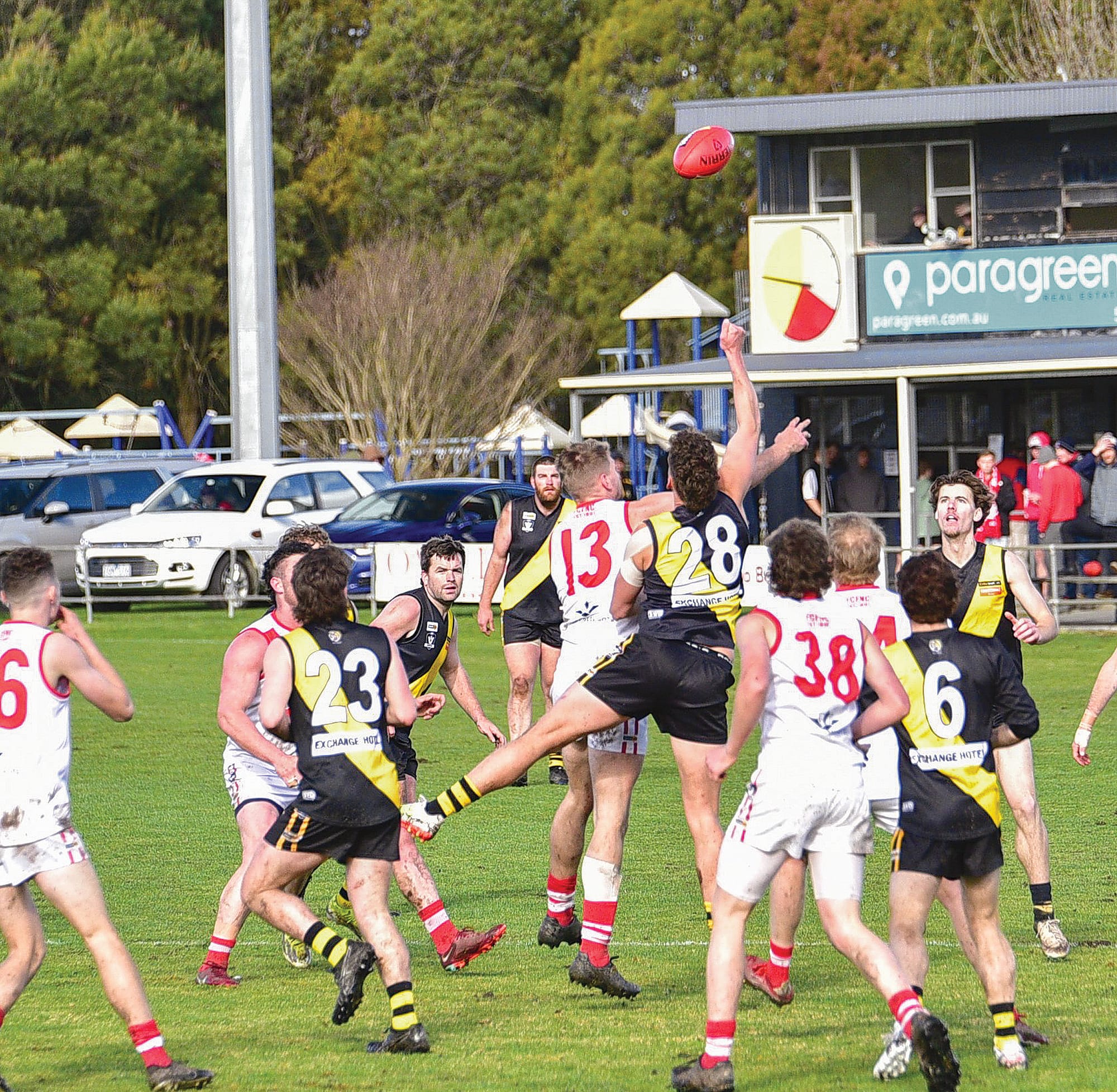 Fish Creek’s Lachlan Gale and Foster’s Troy Van Dyke compete in the ruck as players from both sides swarm around the footy.