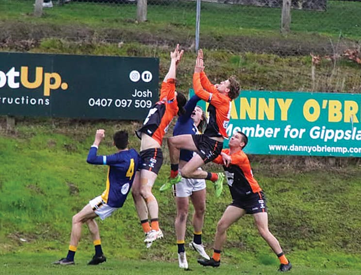 Korumburra-Bena’s Tom Crocker and Tyler Newton fly for a mark.