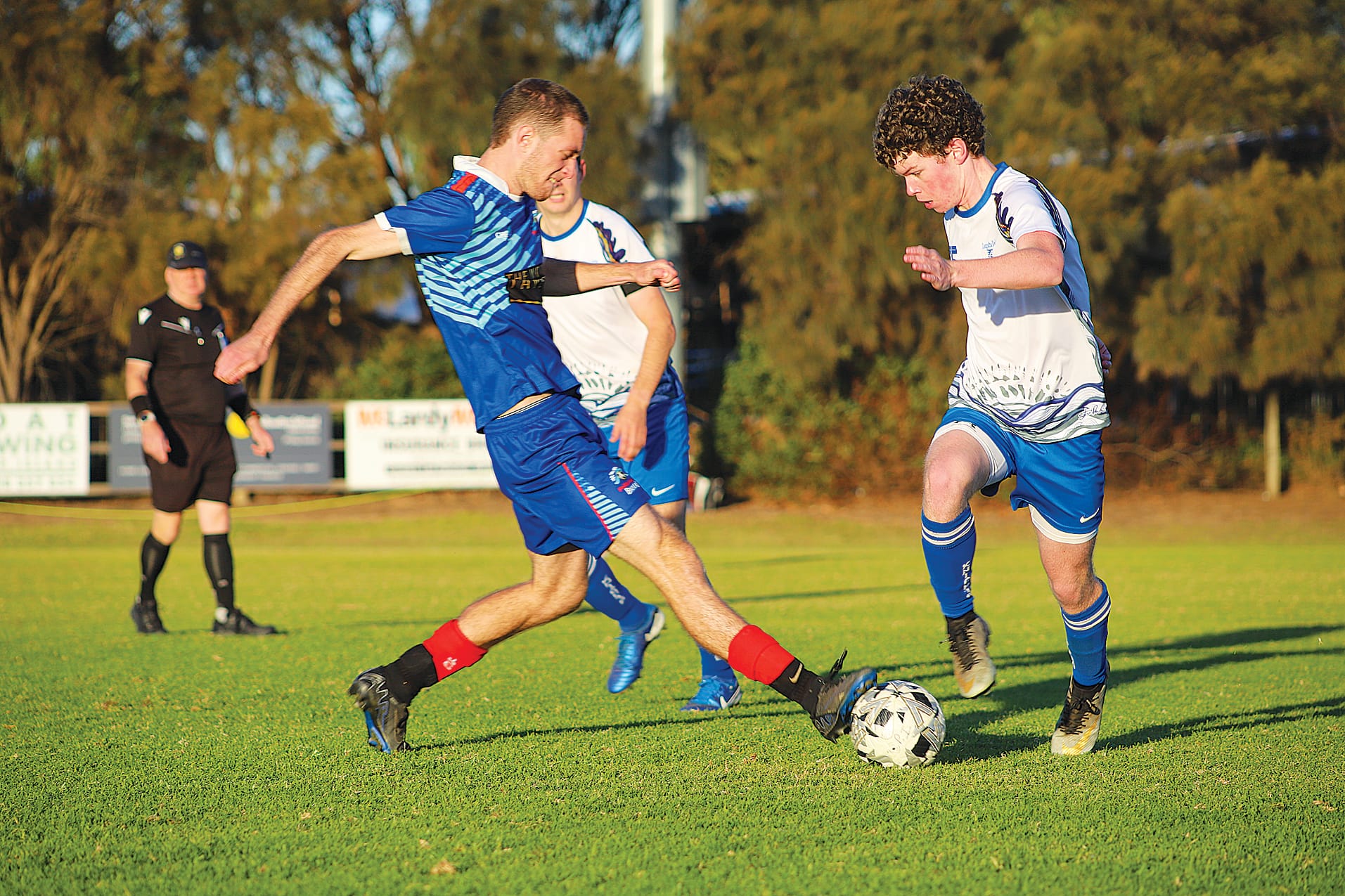Phillip Island’s Centre Back Jack Middleton moves to shut down Leongatha’s&nbsp;Patrick Wilson in midfield.&nbsp;