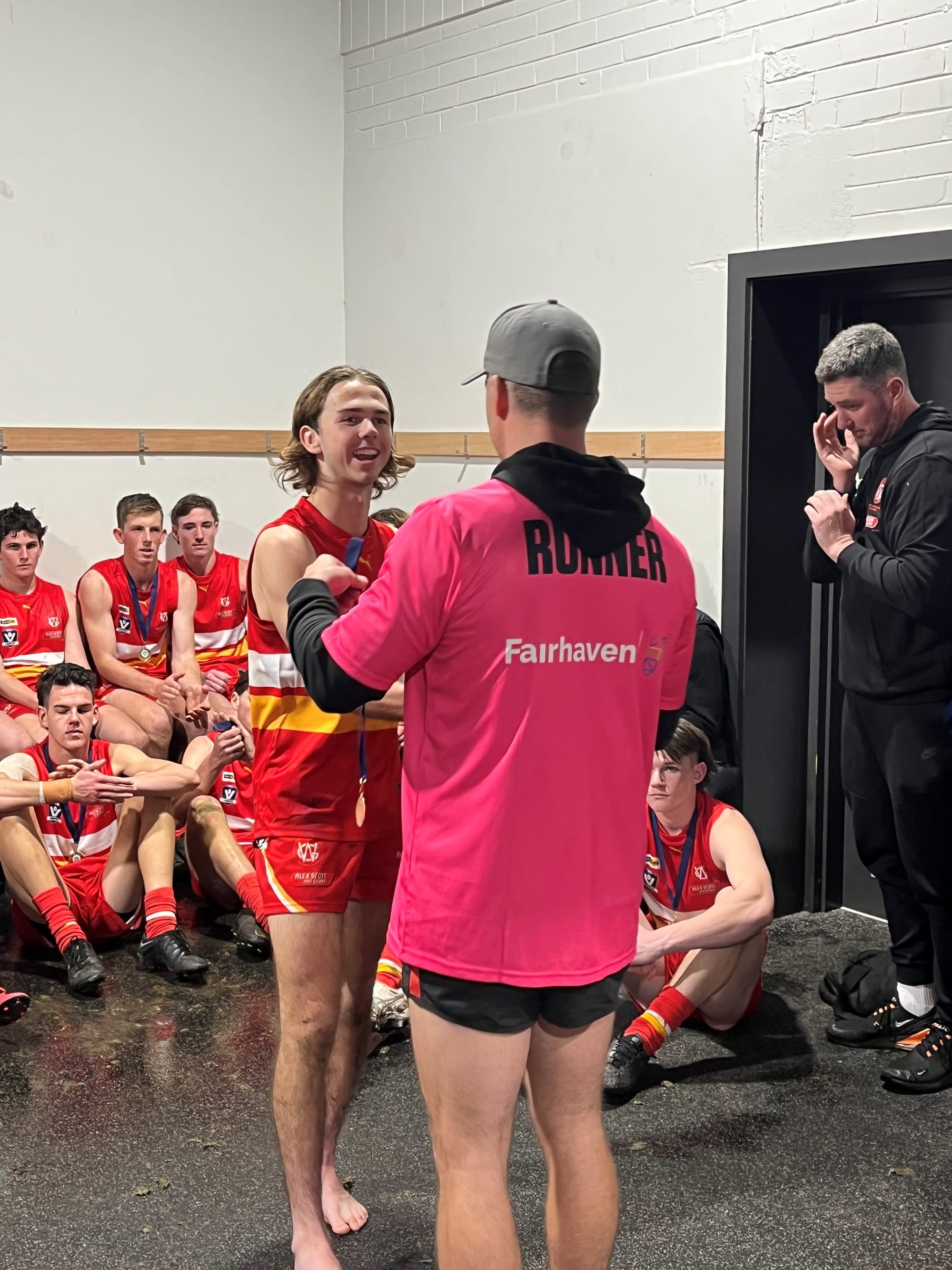 Phillip Island’s Ben Taylor receives his medal for player of the carnival, from league legend Jaymie Youle. 