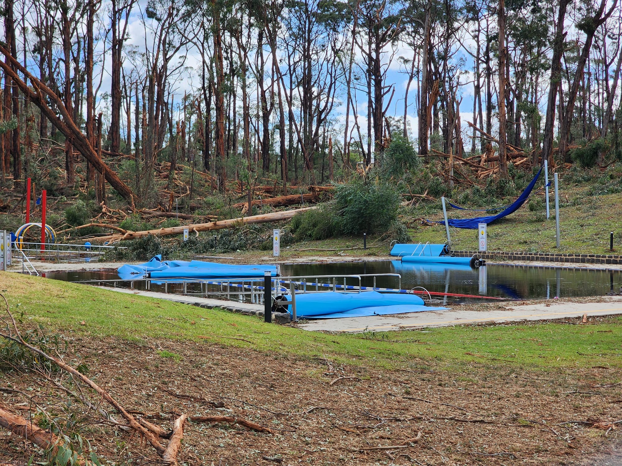 The back fence and pools lie in disarray in Mirboo North after the eye of the storm passed through.