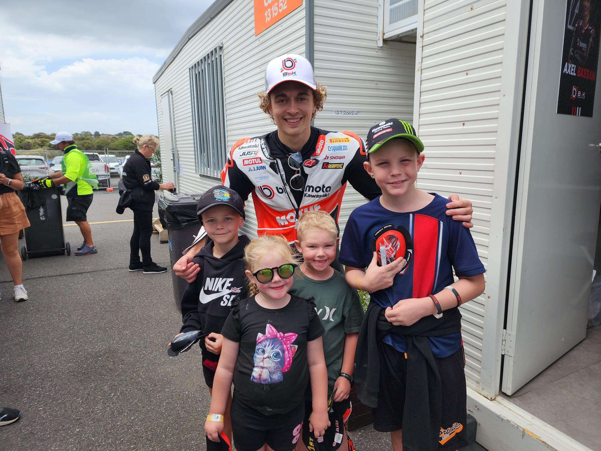 bimota by Kawasaki Racing Team's Axel Bassani was tracked down by the kids giving away his knee pads and graciously signing them.