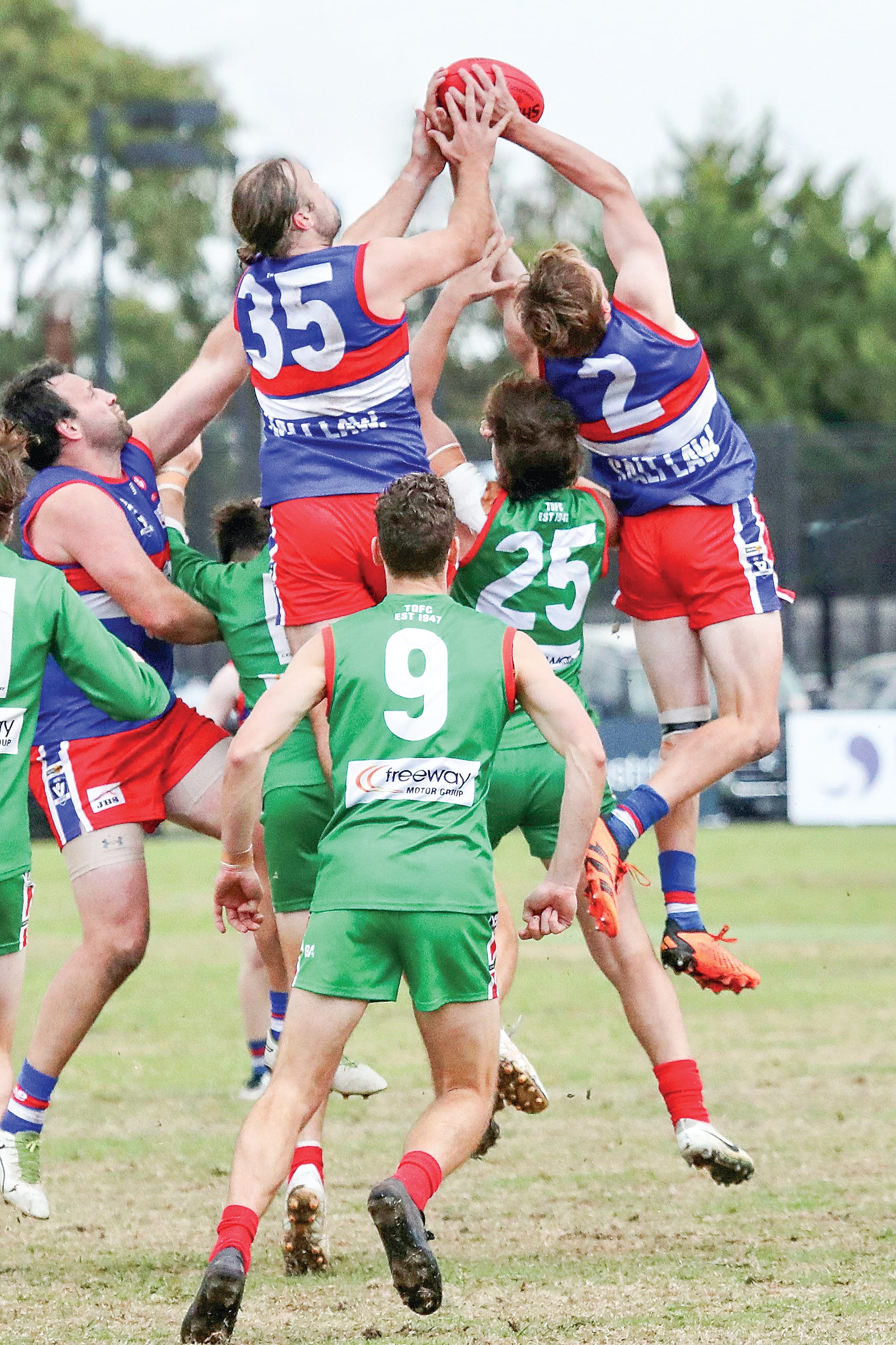 Max Walton marks for Phillip Island just ahead of his skipper Jack Taylor, while Tooradin-Dalmore’s Jack Flannery fails to get the necessary elevation.