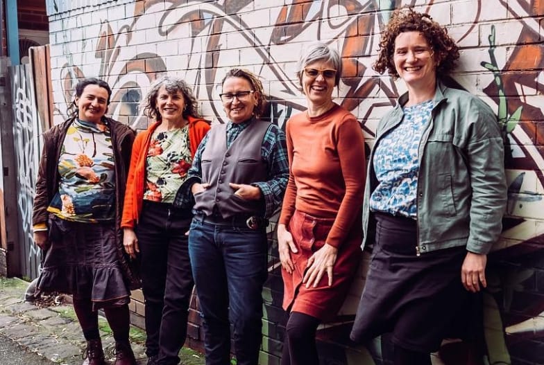 The Cherry Reds: Songwriter Rachel Wilson on lead vocals and acoustic guitar, lead guitarist Poppy Turbiak, bass player/singer Heidi Sanghvi, singer Emily Hayes, and drummer/singer Fionn Ellwood.