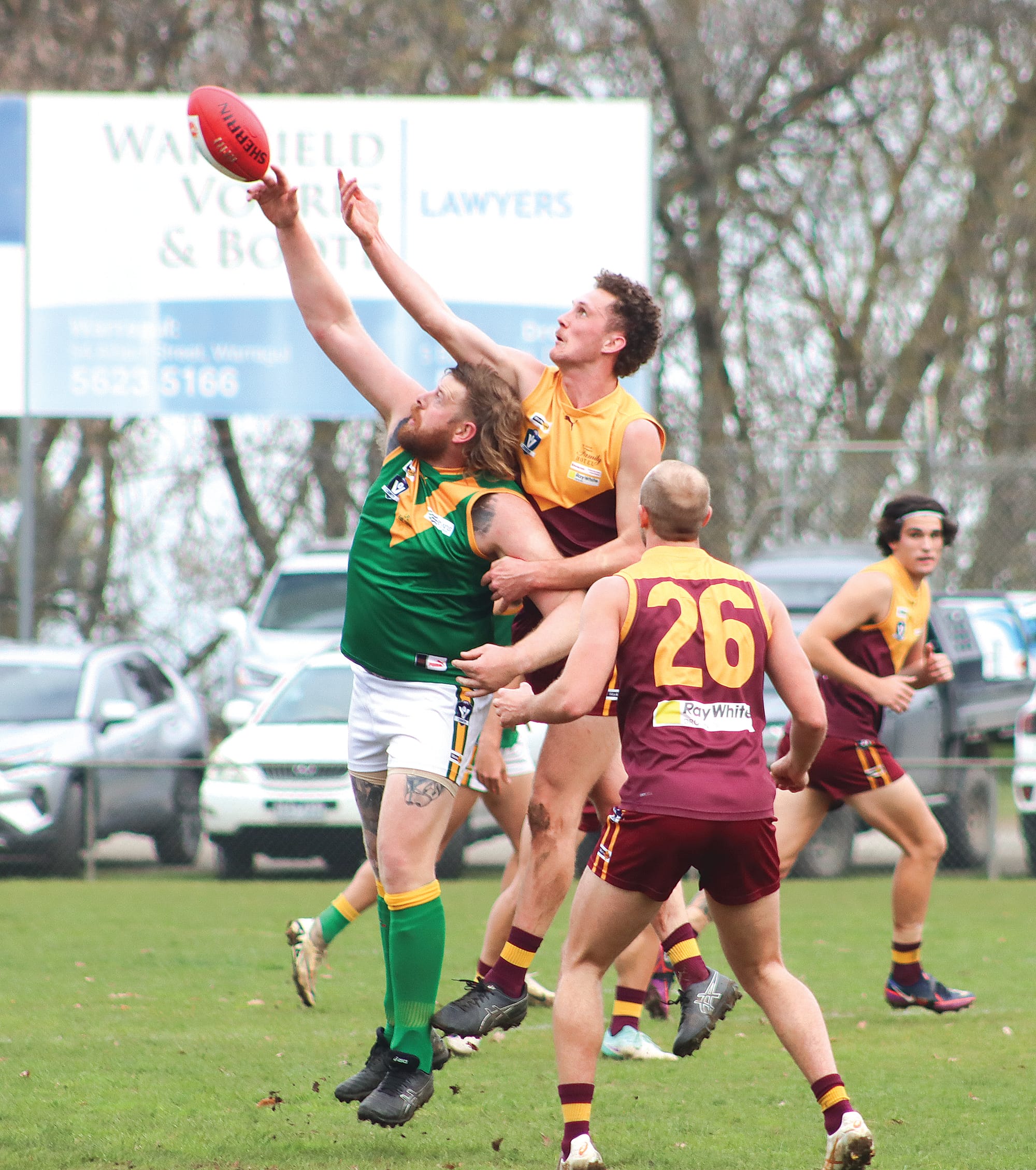 Ben Willis gets his fingers on the Sherrin in this graceful ruck contest during Leongatha’s win over Drouin. A12_2424