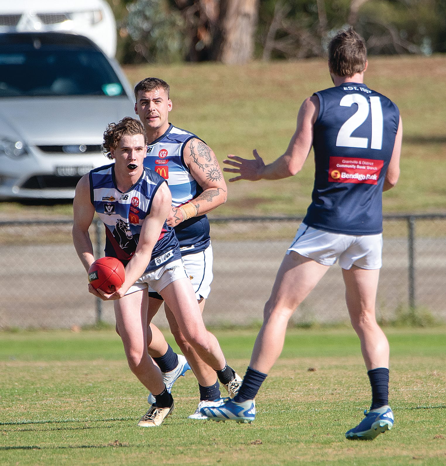 Blake Baker posed to offload the football to his team mate during the Reserves match against Garfield.