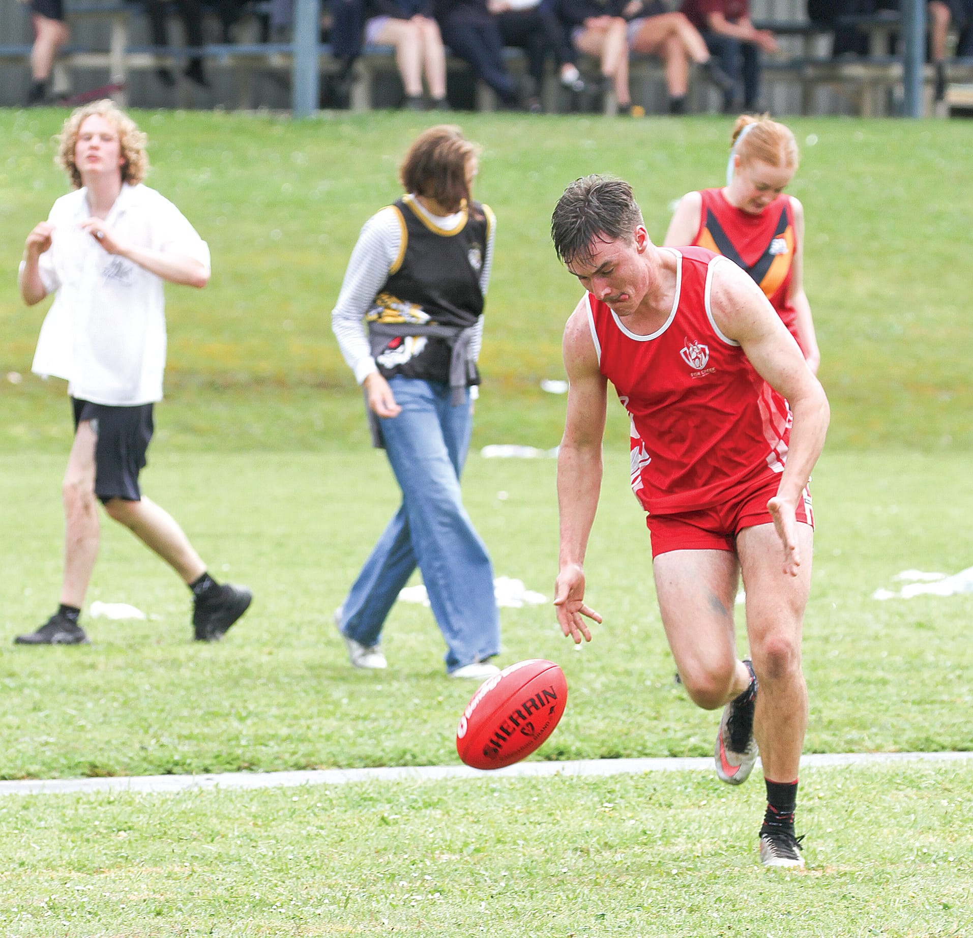 Foster Secondary College teacher scooping up the ball unchallenged.