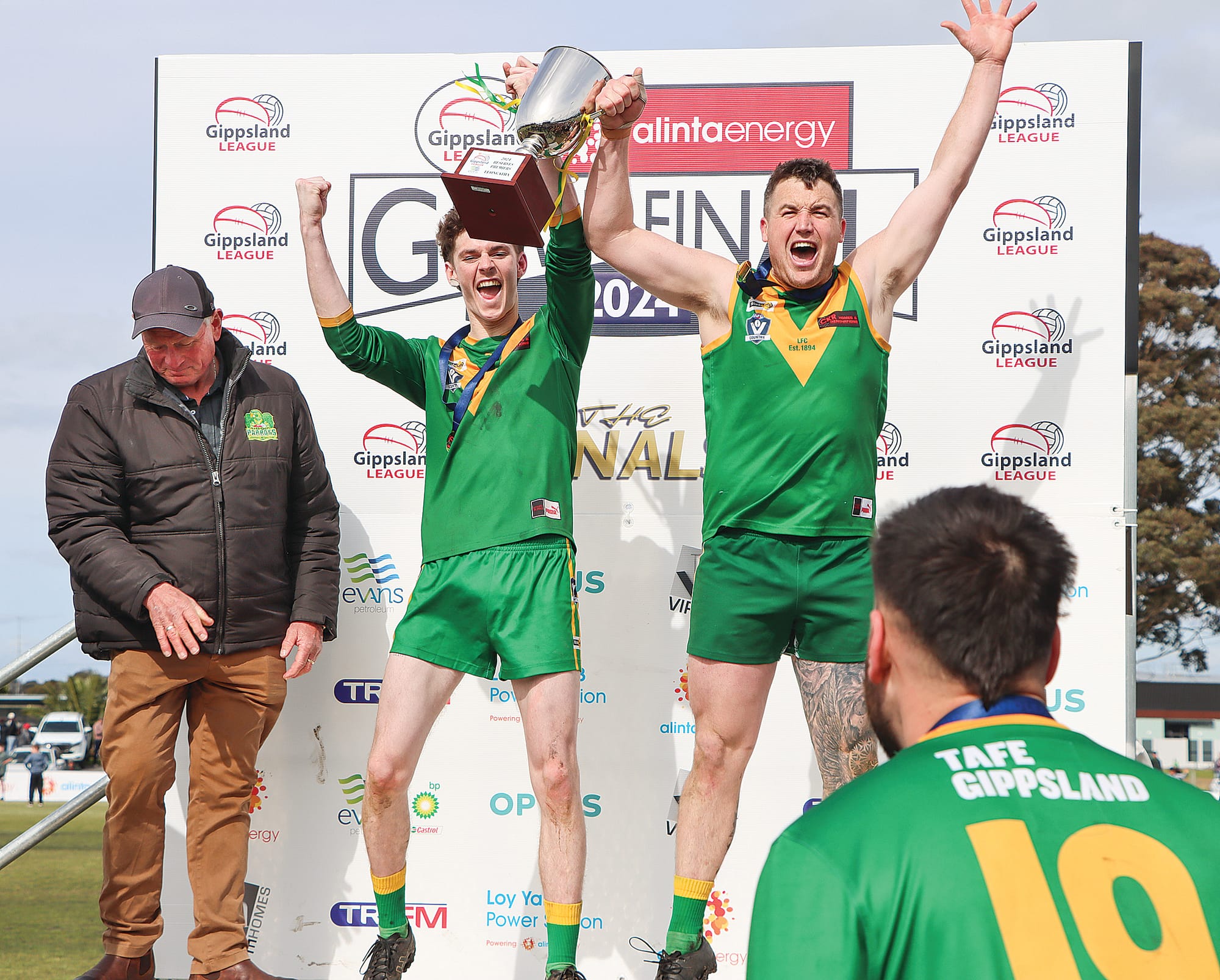 Leongatha skipper Noah Clark and coach Rhett Kelly hold the Reserves Premiership Cup aloft. A61_3924