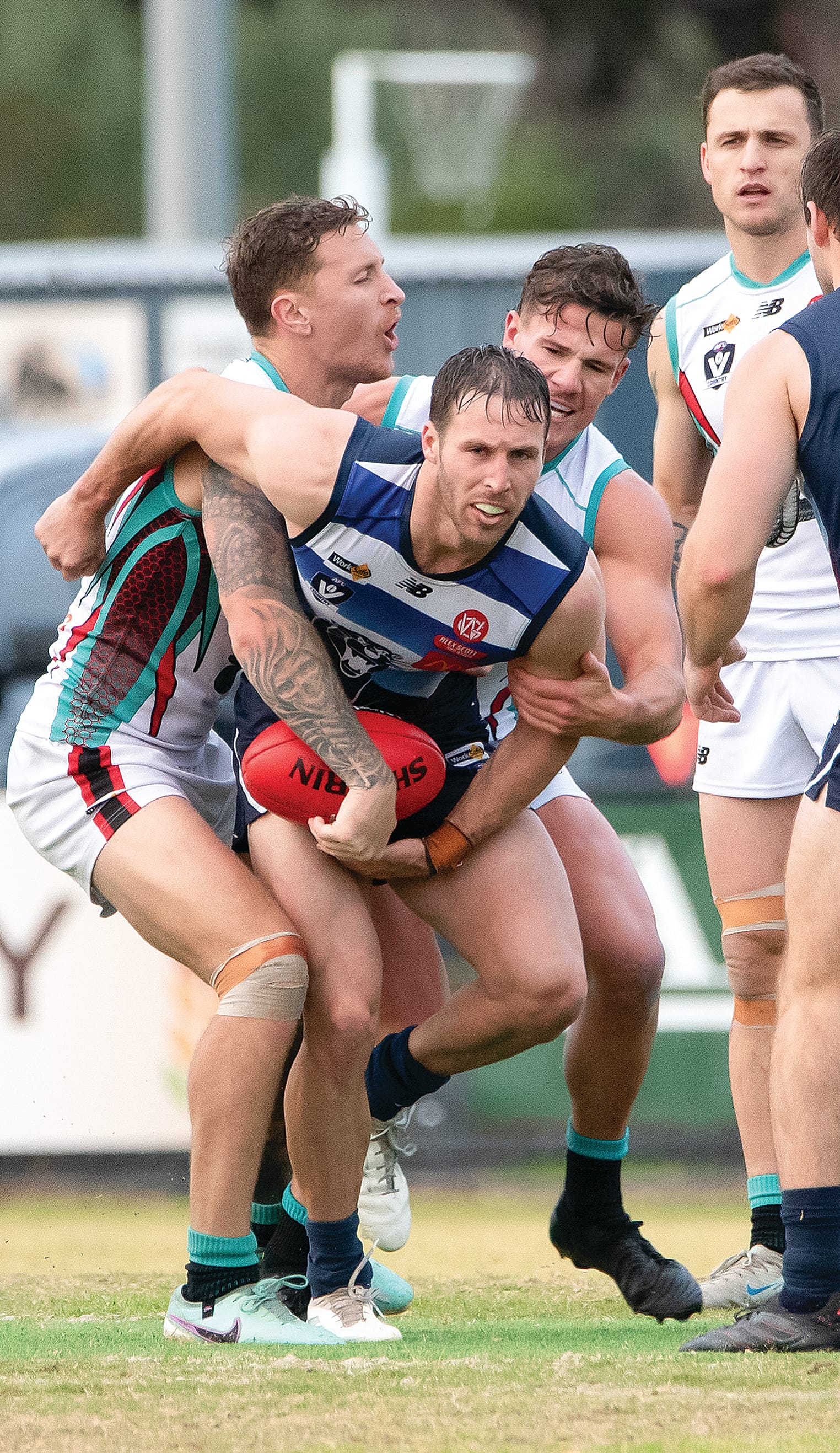 Nathan Foote is gang tackled by two Cobra midfield opponents. Photos: Anna Carson