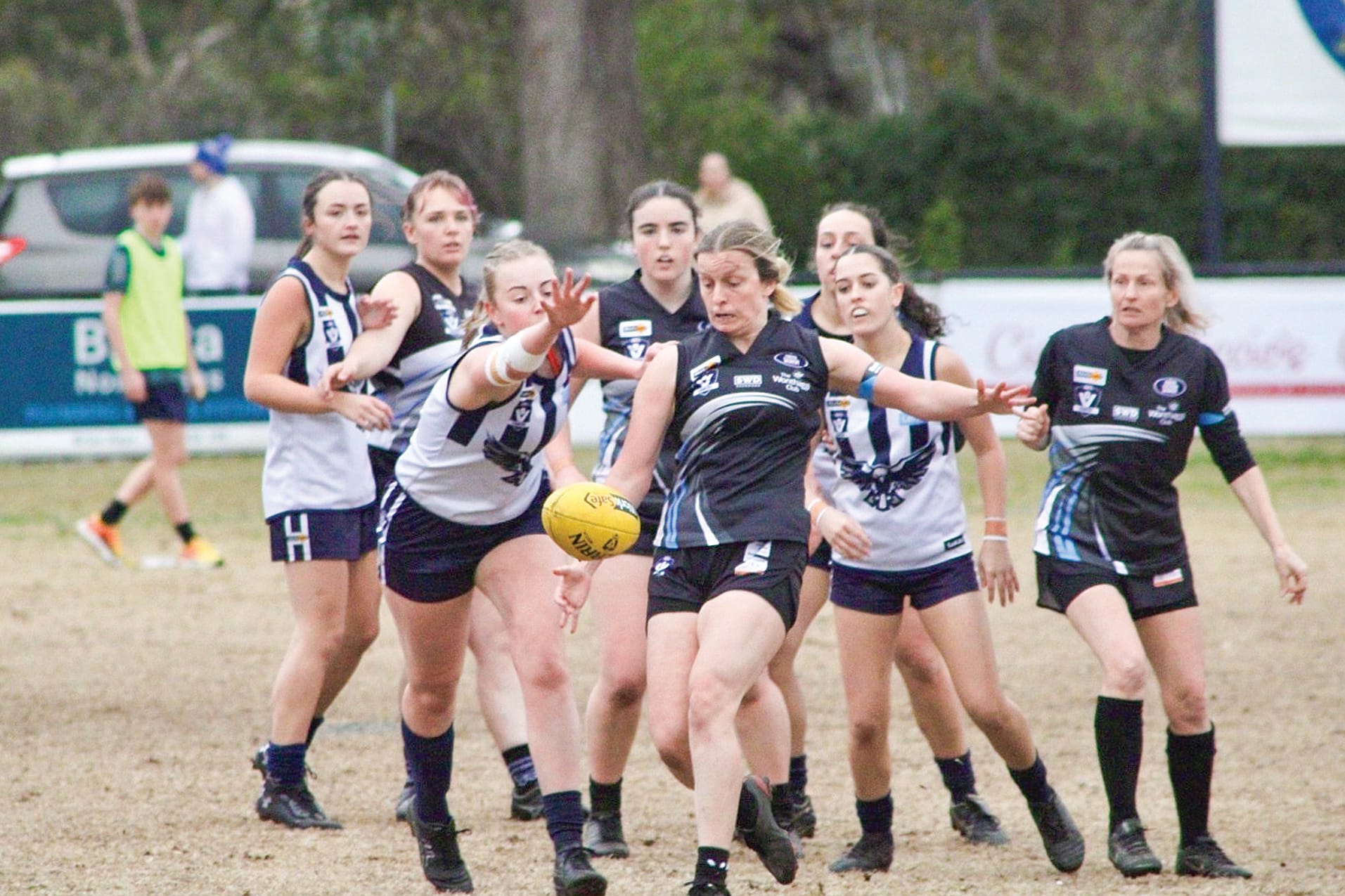Molly Conroy clears the ball with support from team mates
