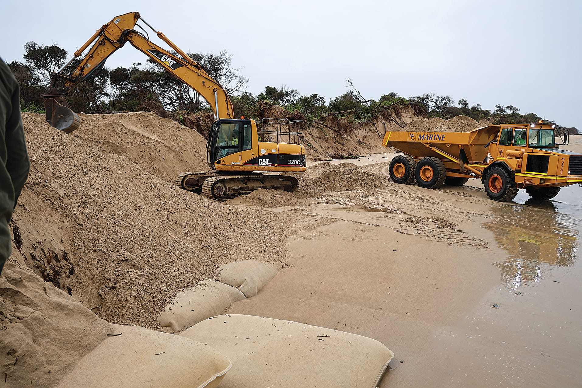Sand has been moved from elsewhere on the beach at Inverloch to backfill the sand eroded from beside and behind the geotextile sandbags in front of the Inverloch Surf Lifesaving Club but locals say it’s a waste of time.
