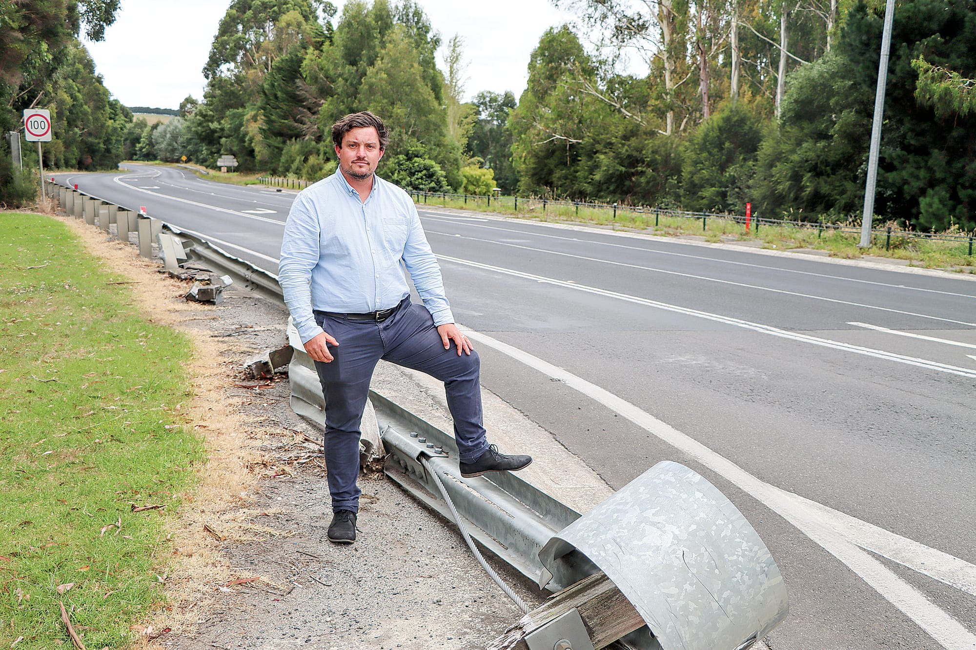 Cr Nathan Hersey highlights the fact a guard rail at the corner of South Gippsland Highway and Victoria Road remains unrepaired. A19_0624