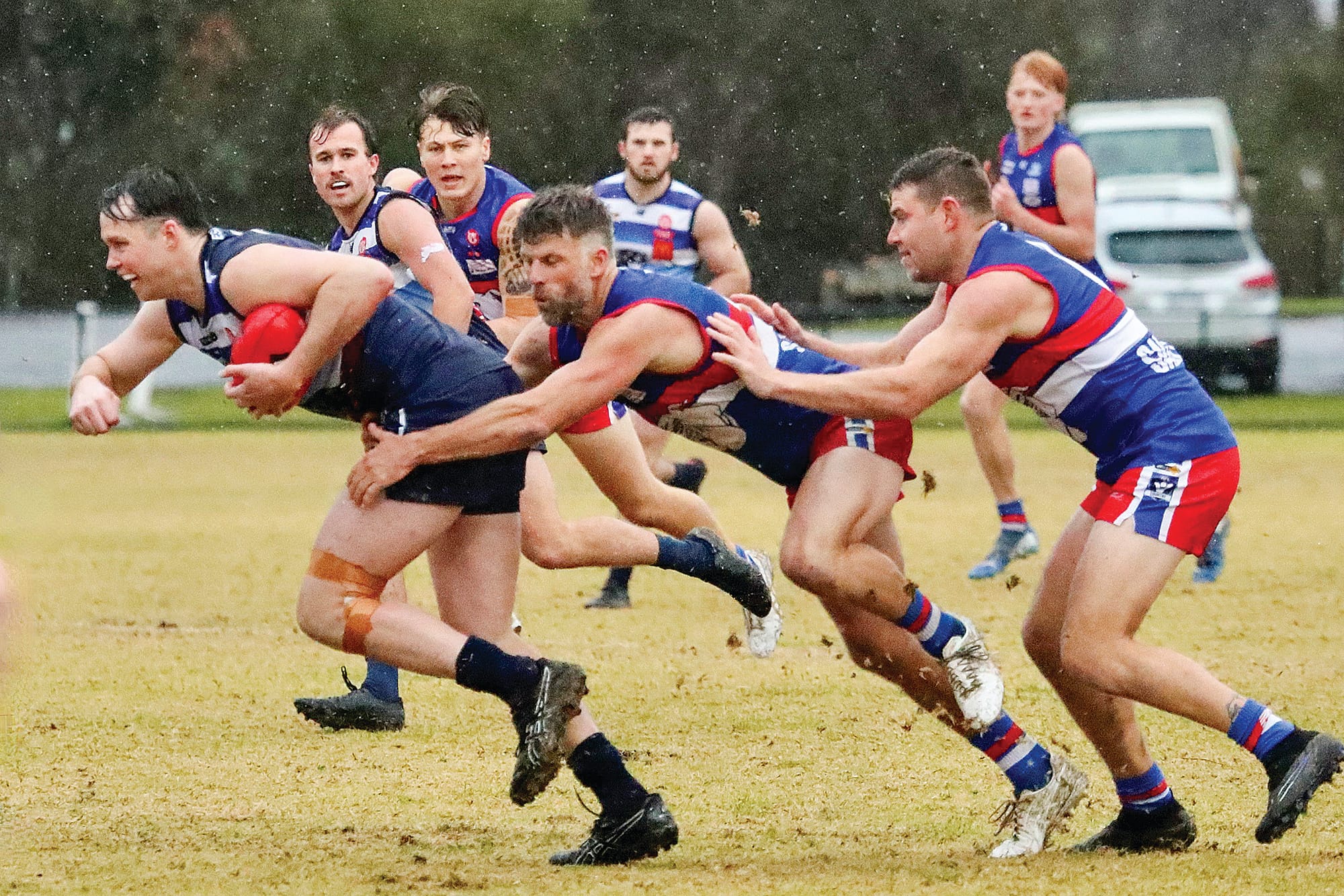 Jaymie Youle and Mark Griffin tackle Timothy Gunn. Photo: Carol Ratcliff