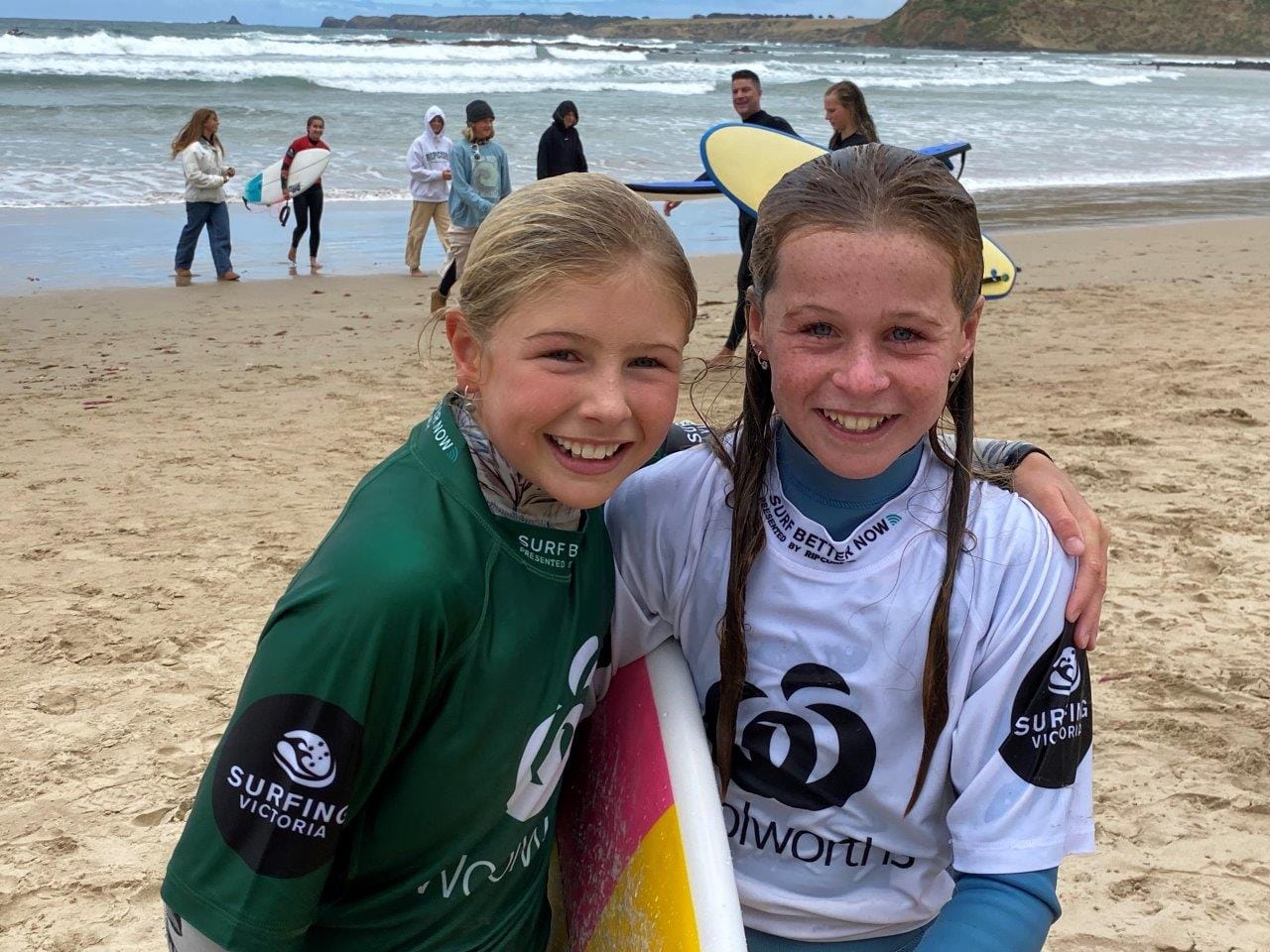 Phillip Island's Scarlett Rennie, (green) second in Round 1 of the Under 14 Girls State Championships congratulates the winner in white, Rose Holland of Dromana.
