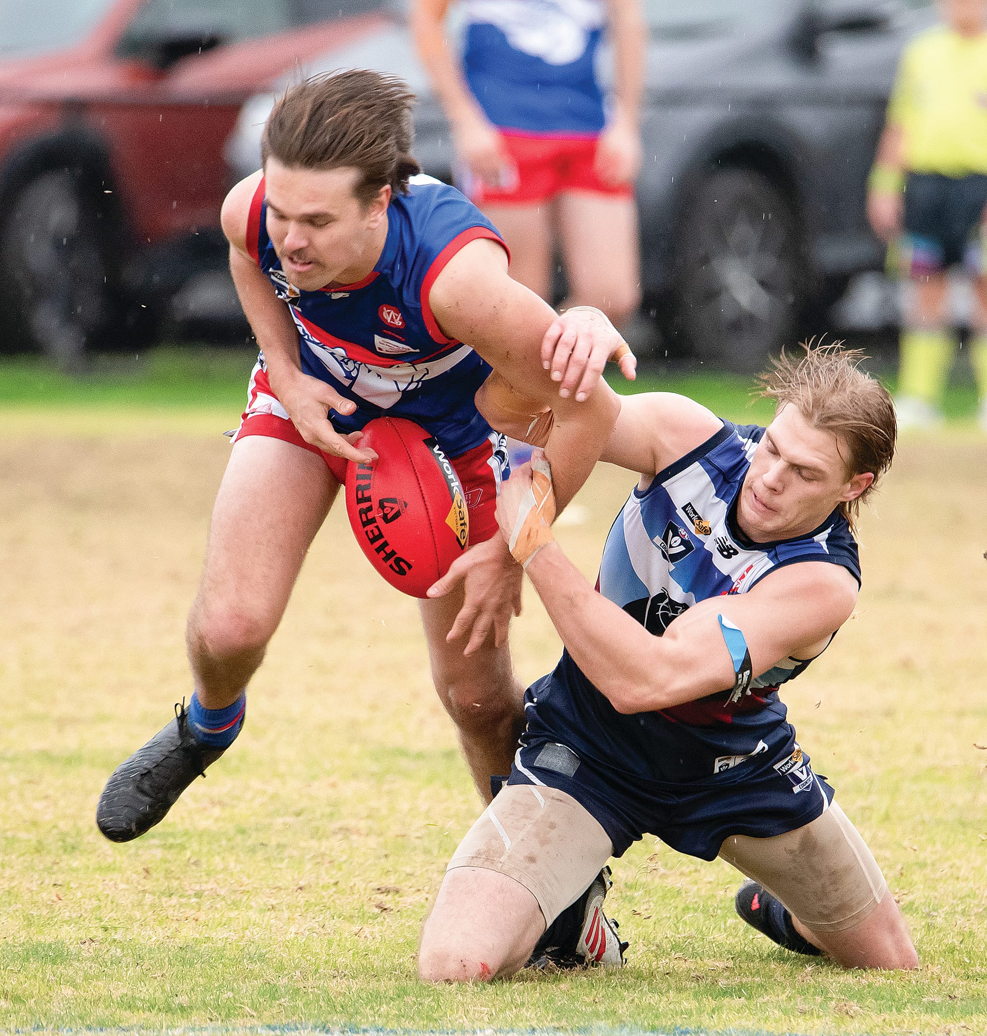 Lachlan Scott and Billy Taylor battle for possession in the wet and slippery conditions at Bass. Photo: Anna Carson