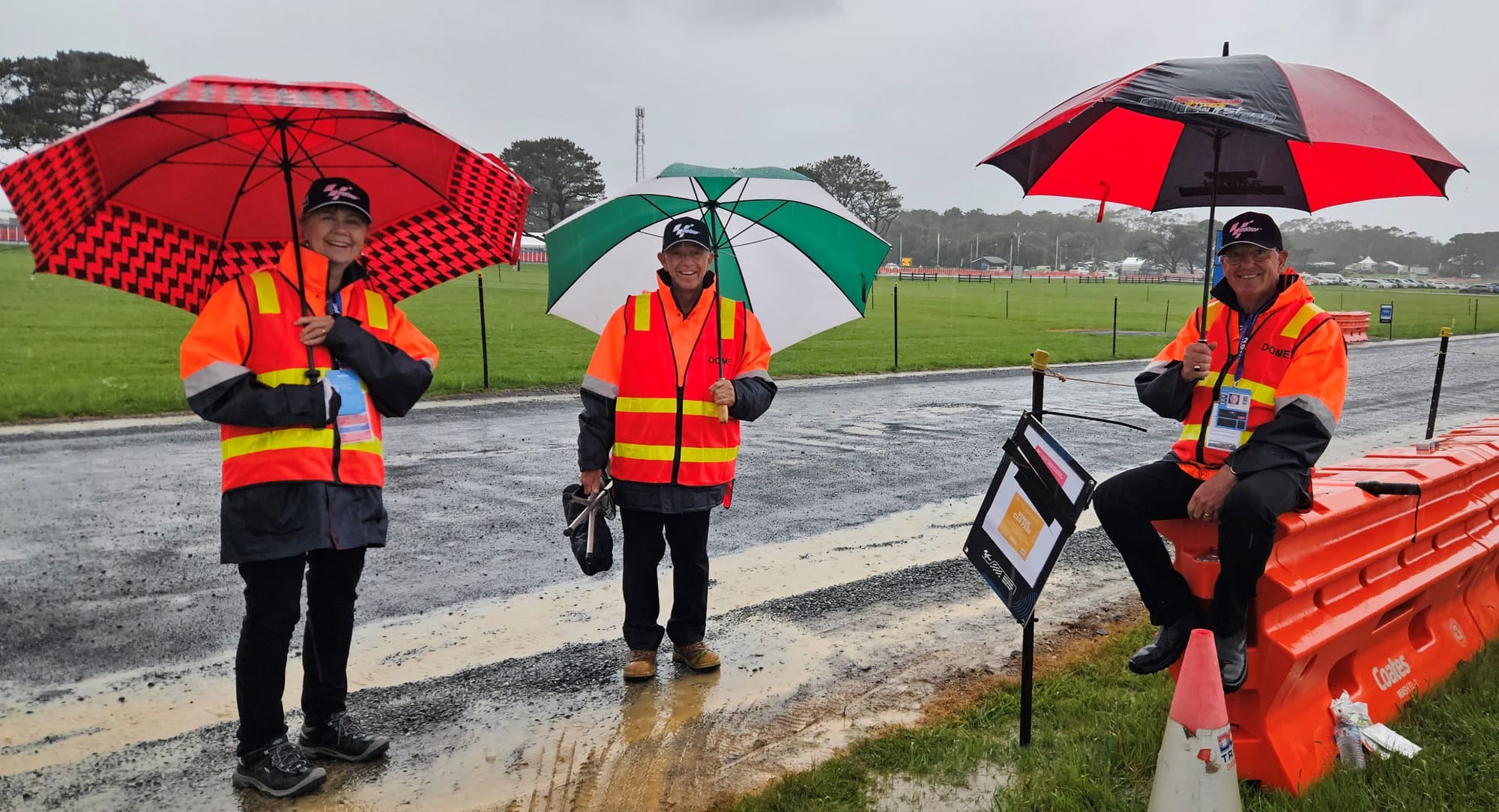 Rotary Club members Rhonda, Peter and Peter preparing to park cars at the Phillip Island Grand Prix.