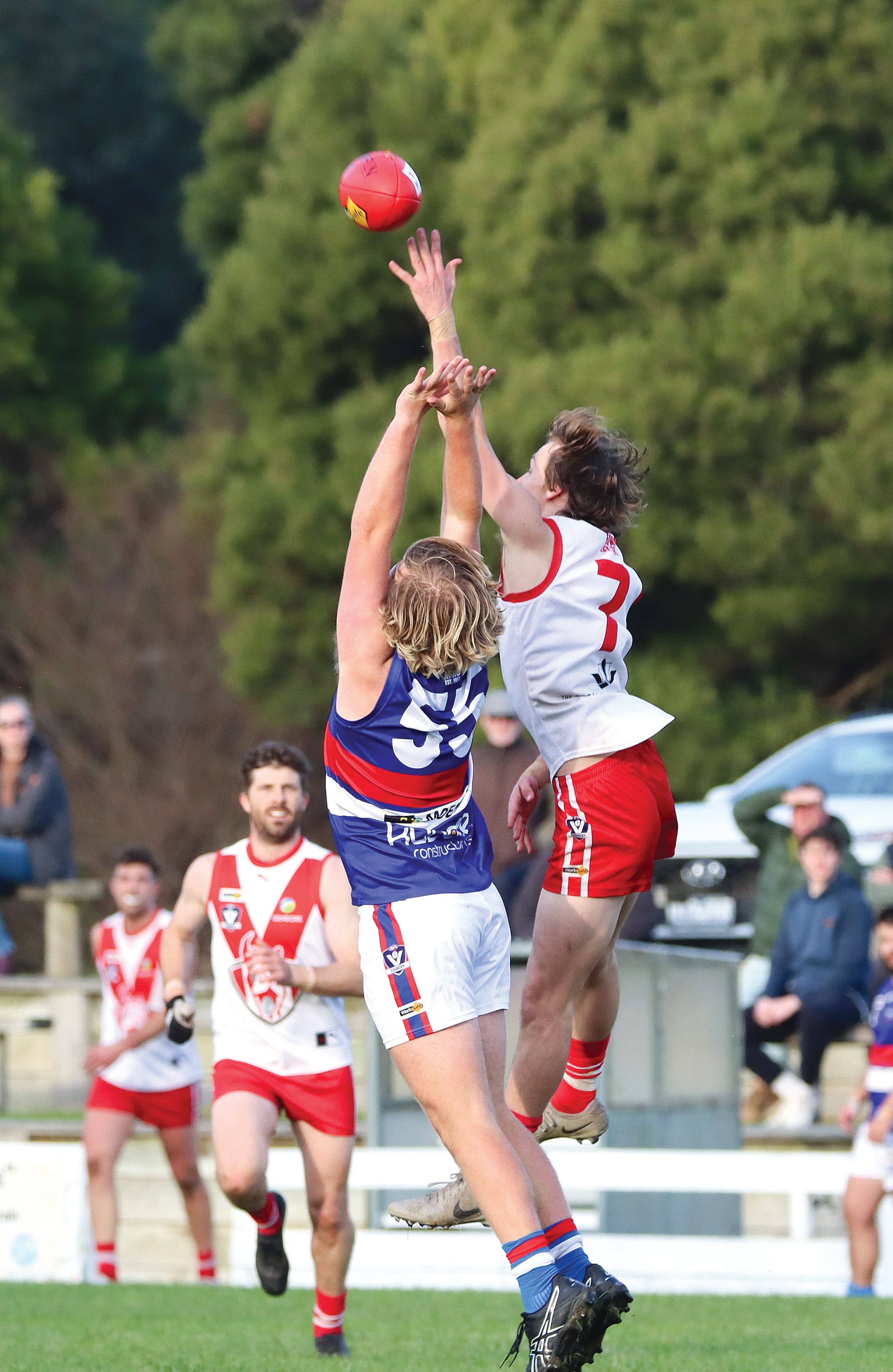 Fish Creek’s Josh Harry and Newborough’s Zach Daley compete in the air. A25_2425