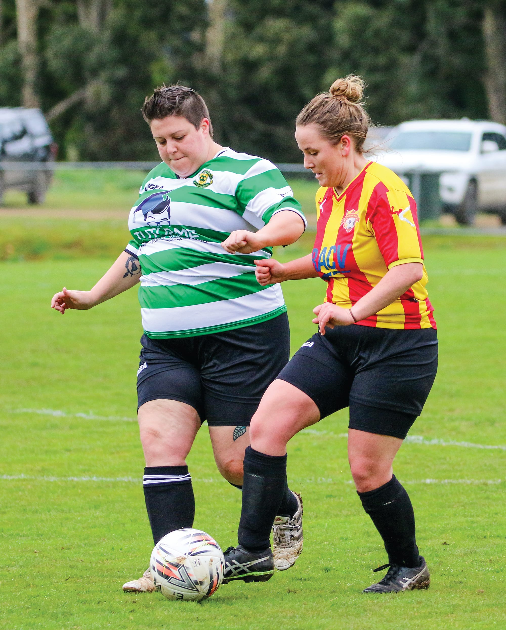 Inverloch’s Lindsay Ritchie protects the ball as she is put under pressure by Mirboo North’s Jess Odgers.