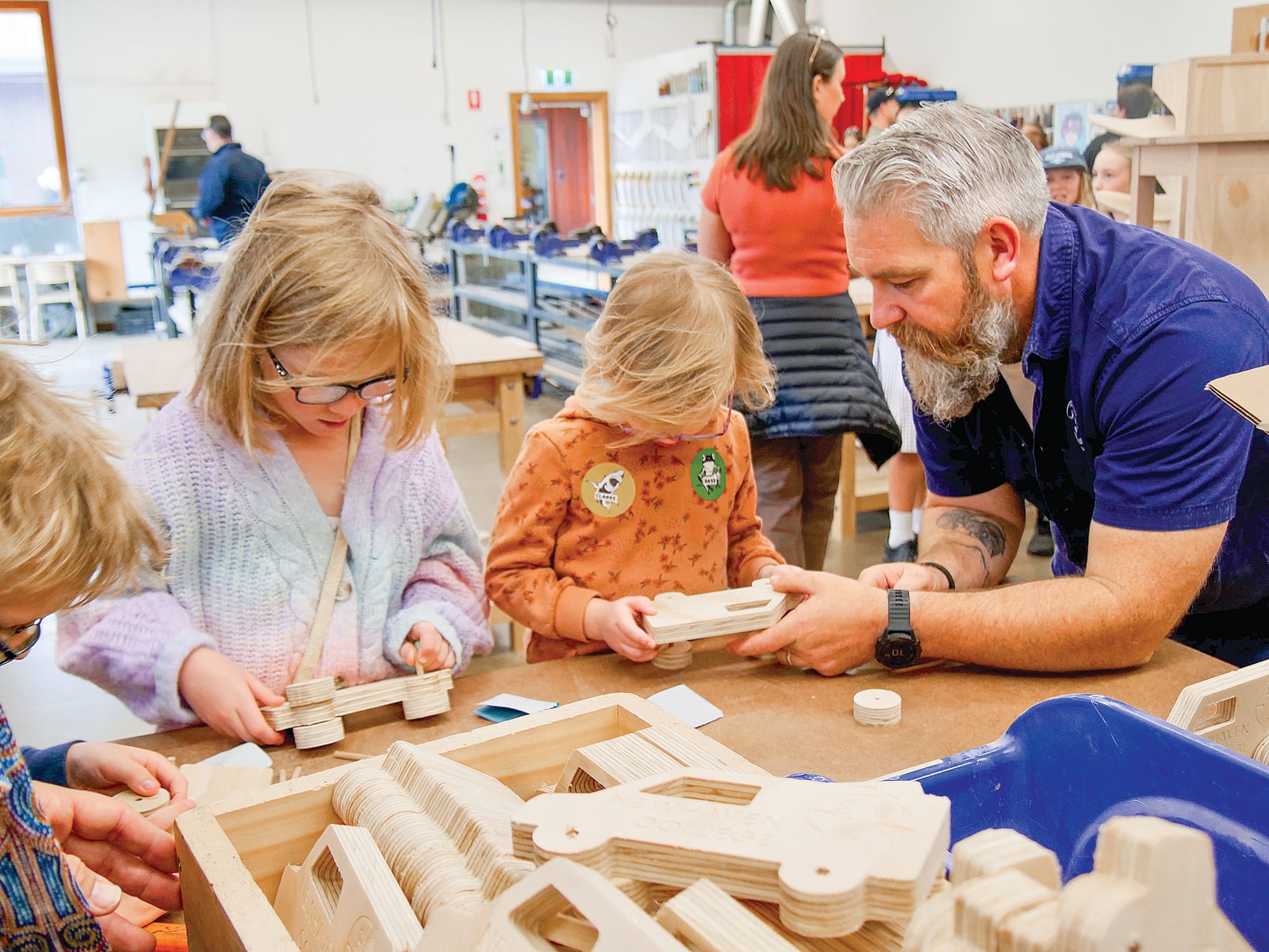 Product design technician Ben Stein assisting some children making wooden cars in the Trade Centre.