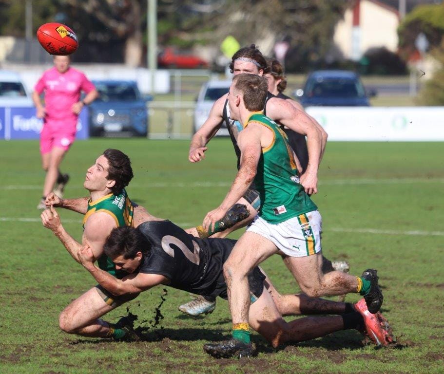 Leongatha’s Kim Drew gets his handpass clear under pressure from Wonthaggi’s Ryan Sparkes. Both players were influential for their respective teams in a tight tussle at Wonthaggi.