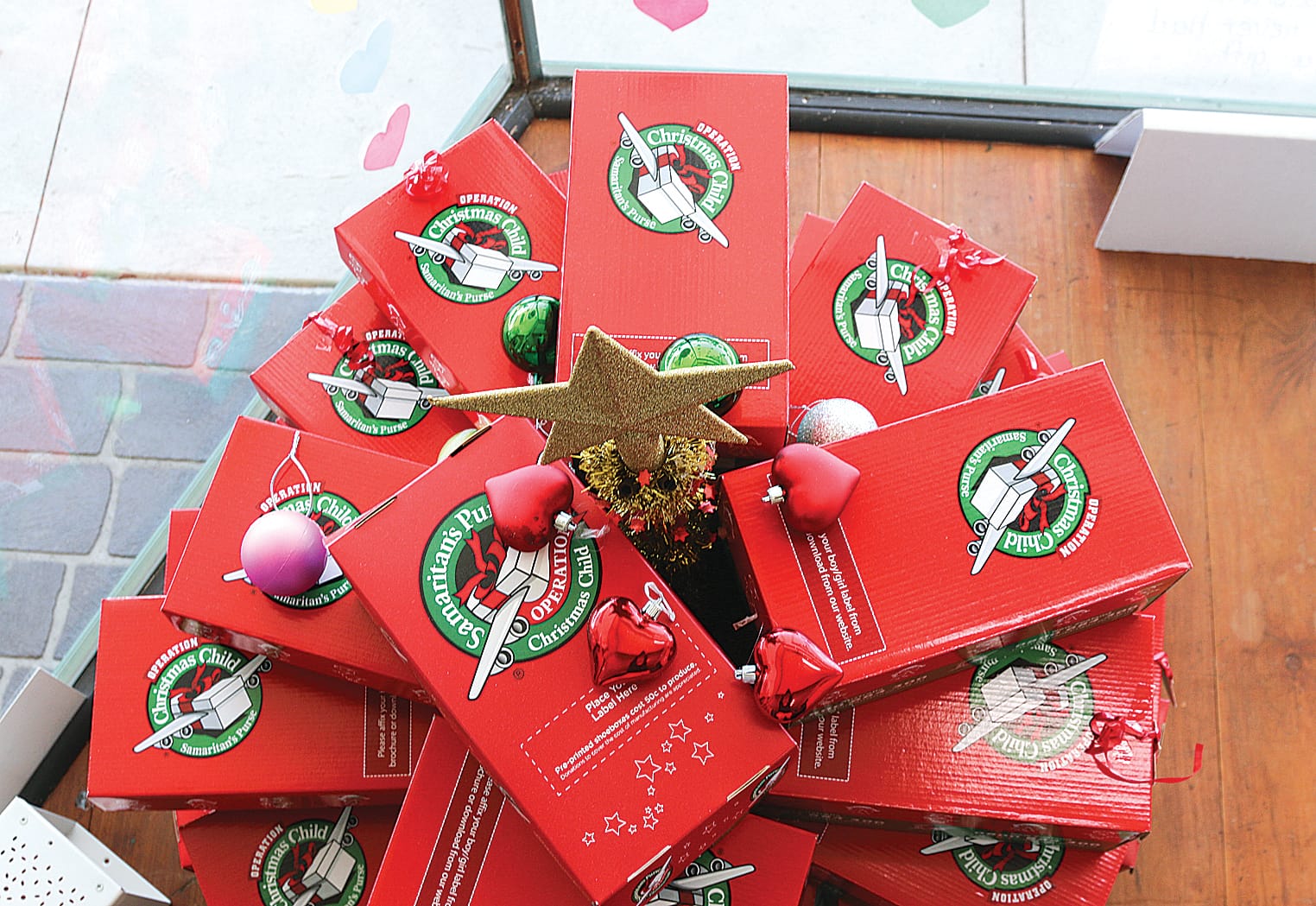 Operation Christmas Child shoeboxes form a Christmas tree at Leongatha’s New Beginnings bookstore.