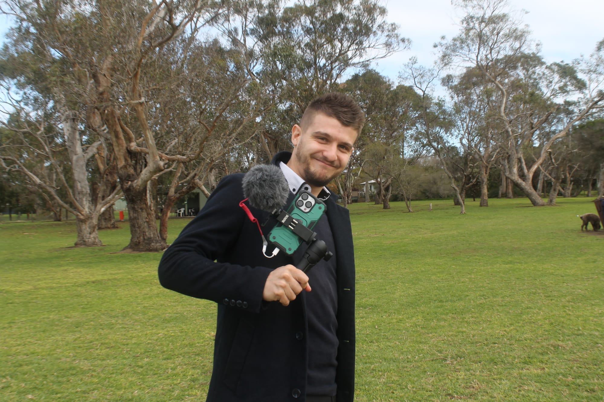 ABC Gippsland reporter Jack Colantuono chatting with dog owners as they slowly return with their dogs to the off-leash area in Blue Gum Reserve. B12_2925