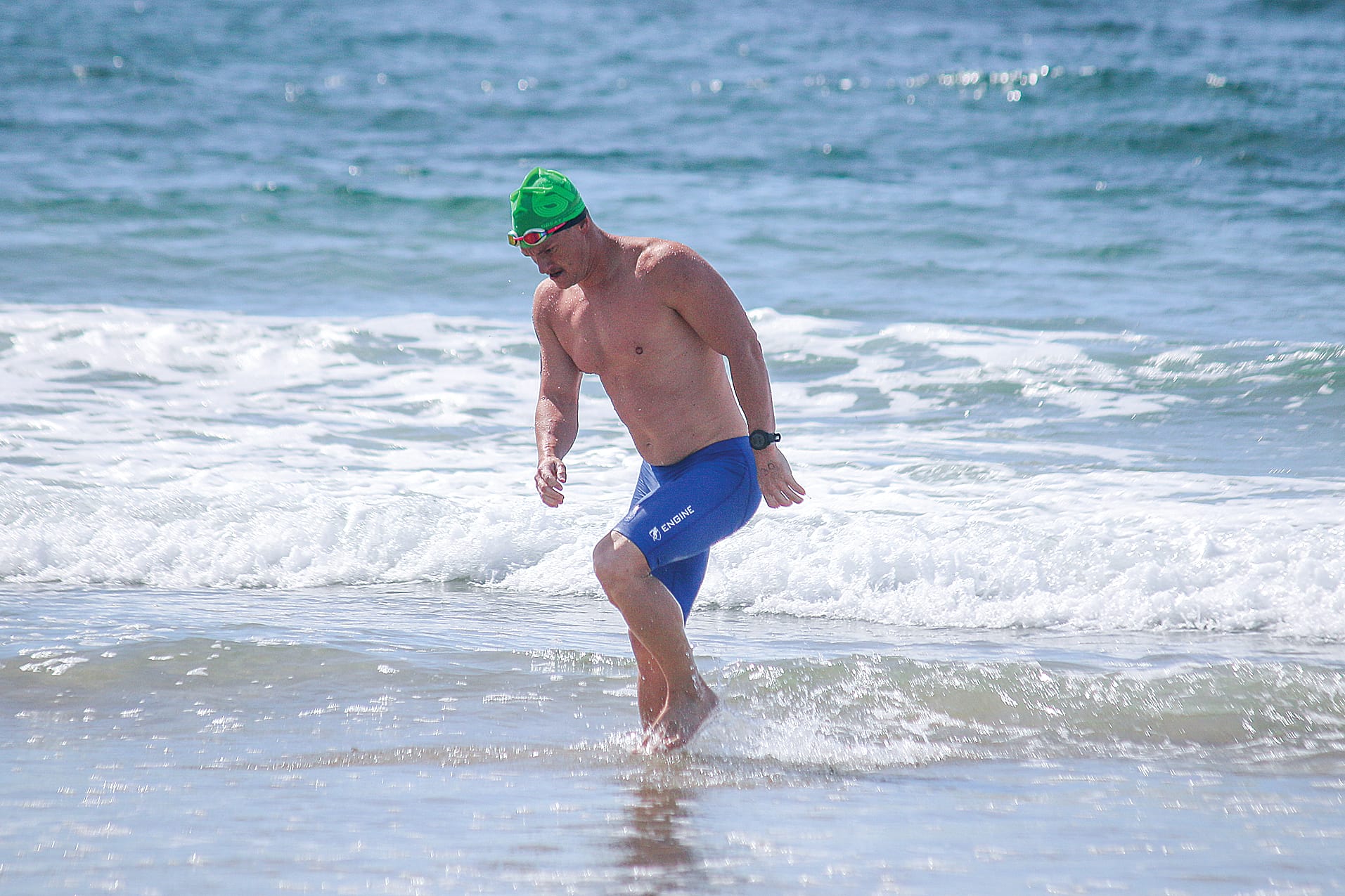 The first swimmer comes out of the water, well ahead of the pack. ob40_0325