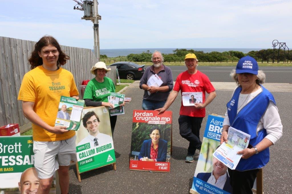Handing out how to vote cards against Kilcunda's spectacular back drop are Shaun Tessari, Jennifer Paproth, Ed Thexton, Paula Street and Russell Savige.