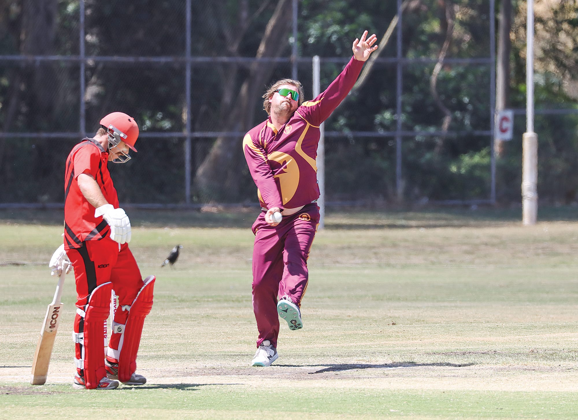 Jake Cochrane gets set to deliver for OMK while Nerrena’s Timothy Whiteman relaxes at the non-strikers’ end. A21_0425