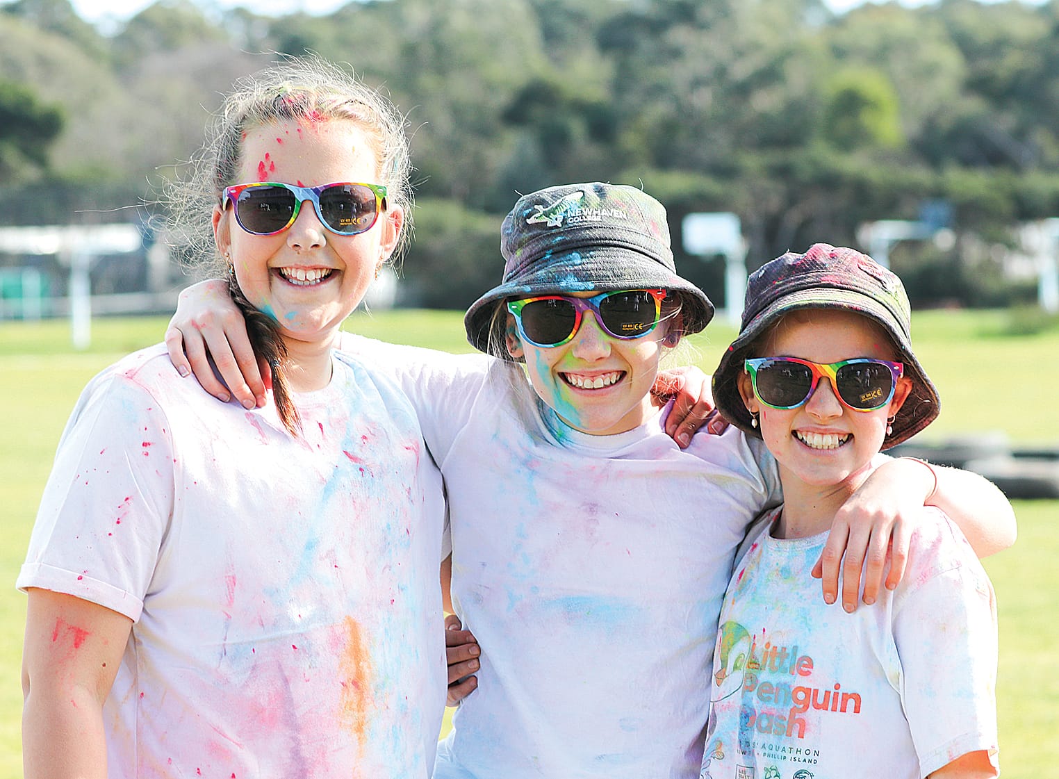 Middle School girls Addison, Frankie and Ivy ran through obstacle course for the Newhaven College Colour Run. Z19_3223