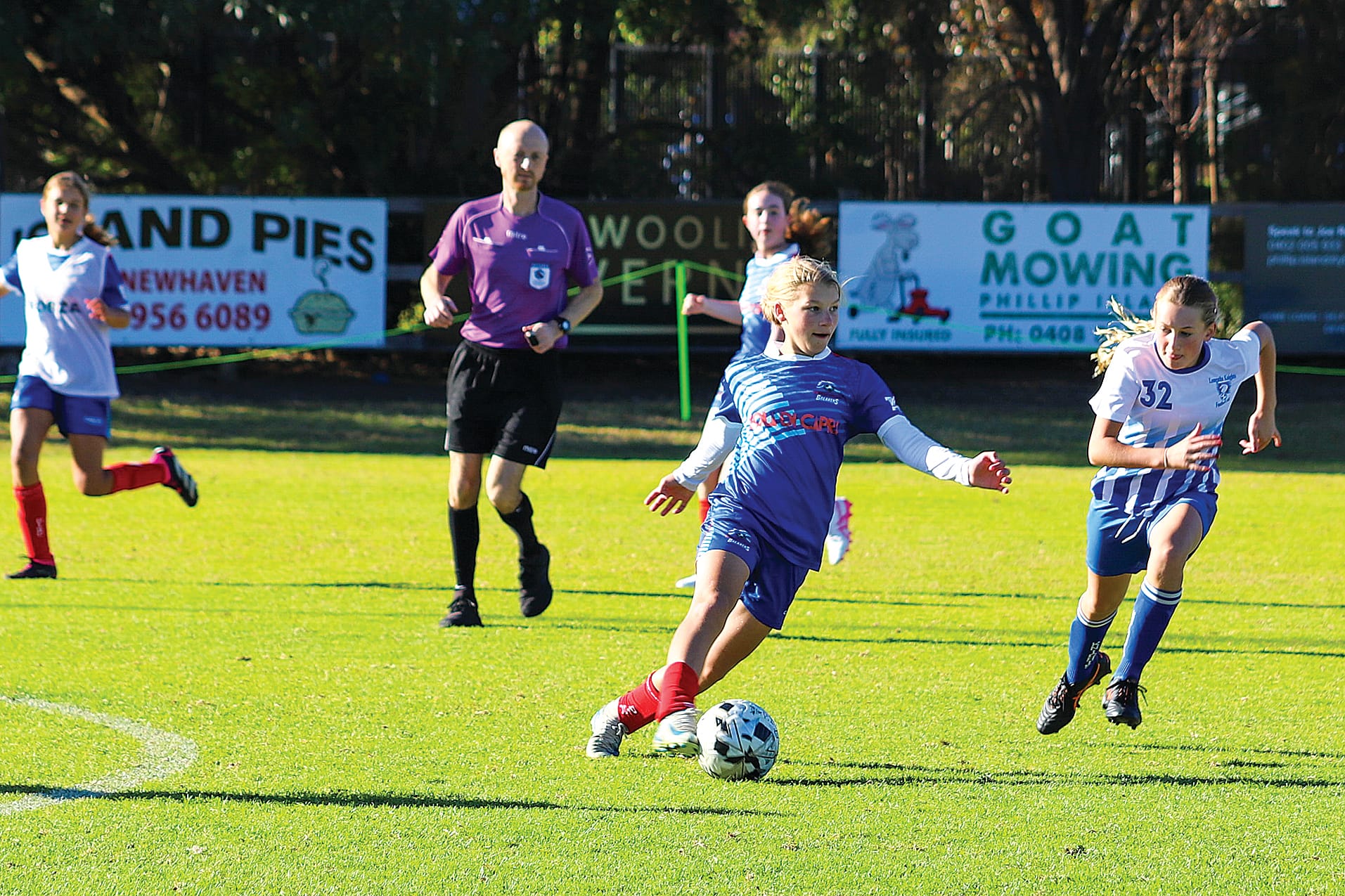 Phillip Island’s Hannah pressured by Leongatha’s&nbsp;Samara in midfield during the U15 Girls Game. 
