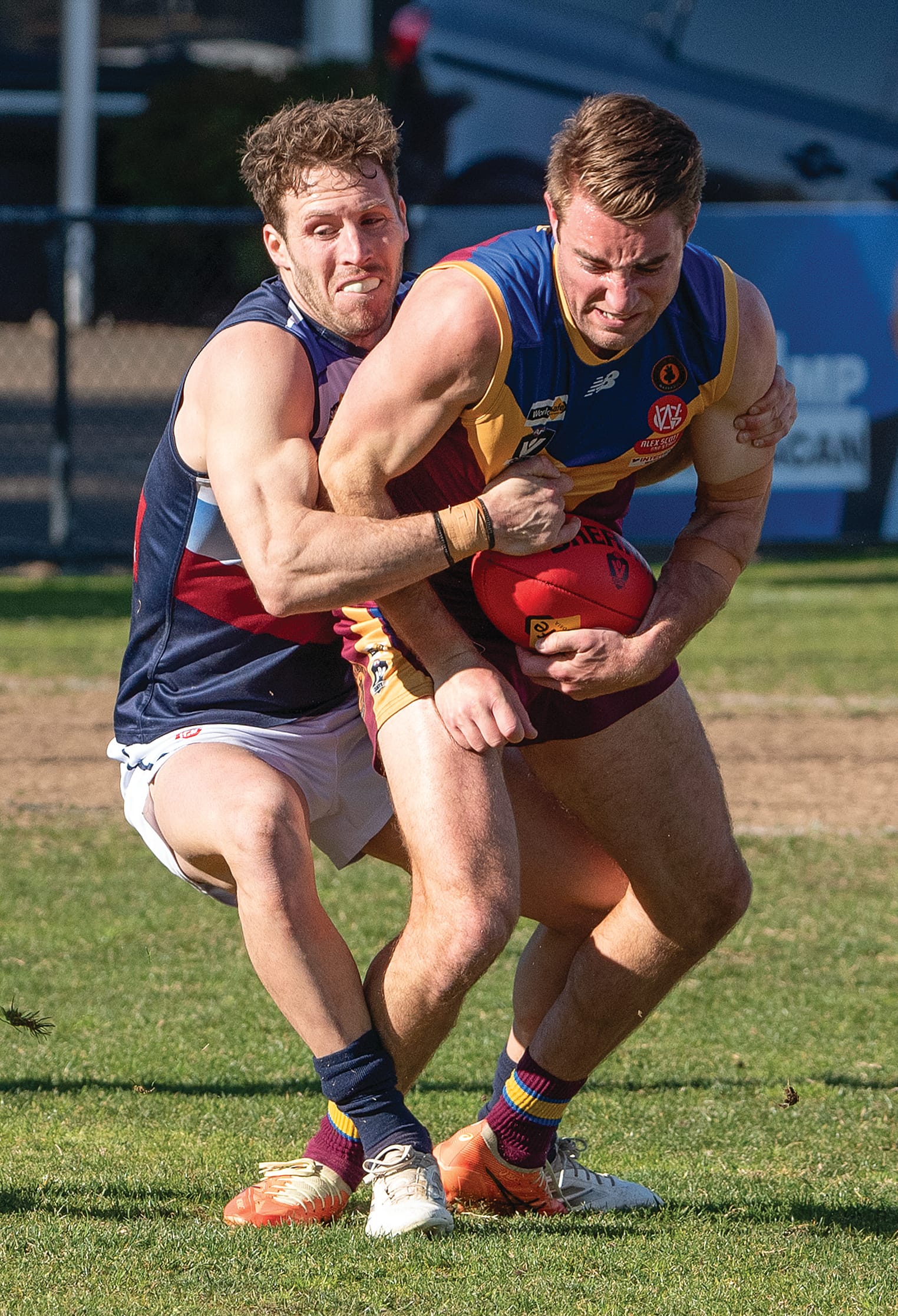 Nathan Foote lays a strong tackle on his Warragul Industrials opponent.