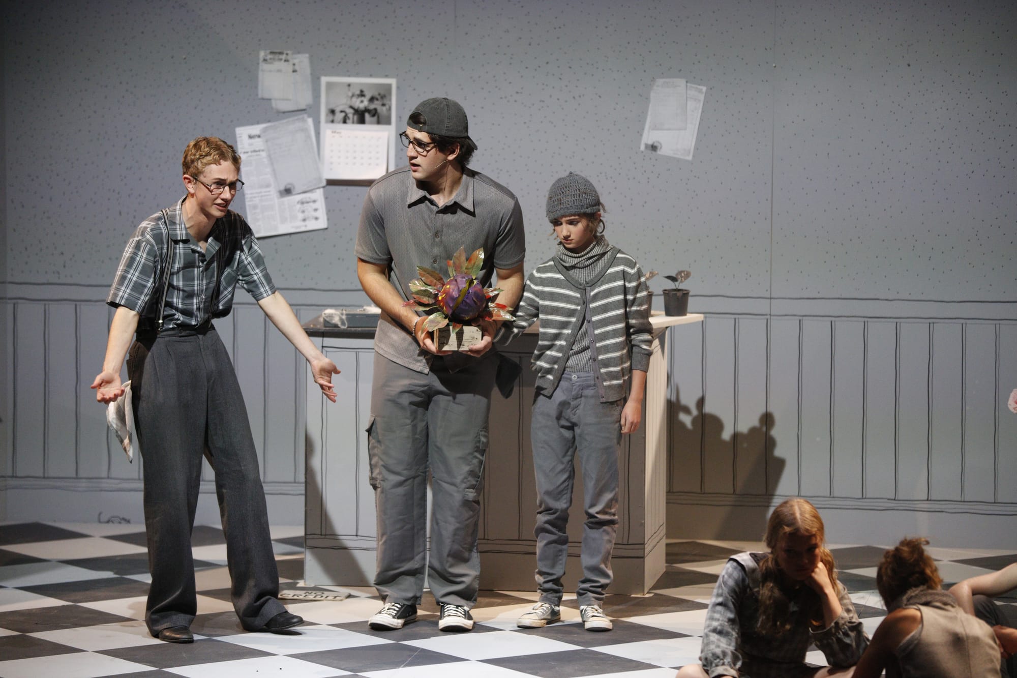Felix Fothergill as Mr Mushnik and Dean Lyle discover the young Audrey II is not as innocent as it seems, with puppeteer Ariana Ward. Photo: Leo Edwards