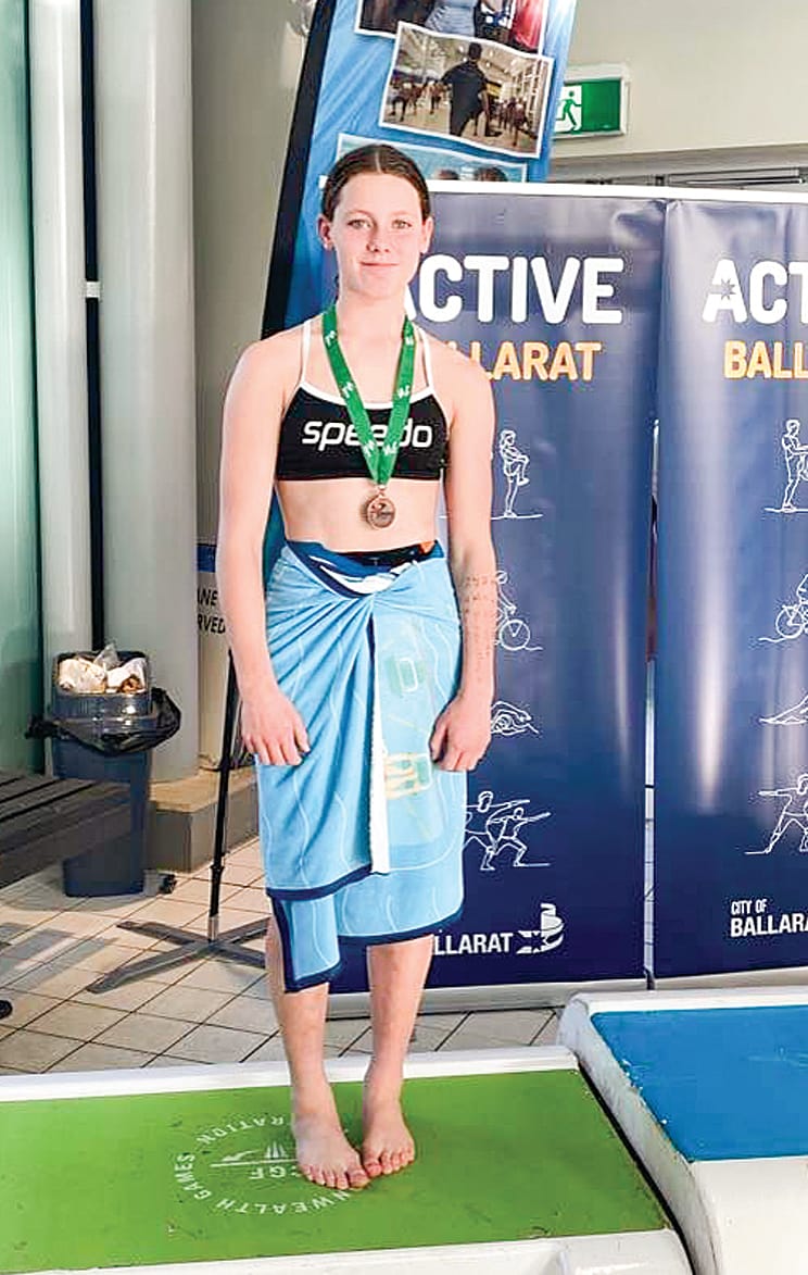 Olivia Holmes with one of her medals.