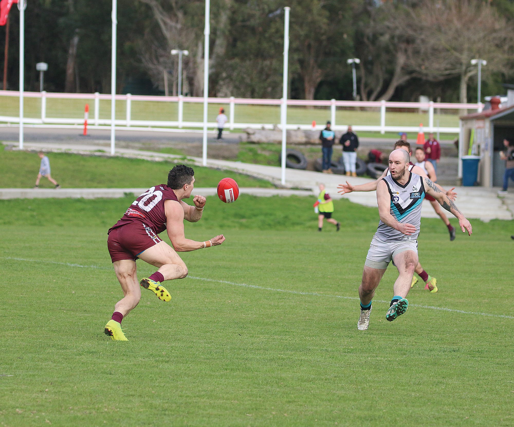 Kael Bergles, one of the best on ground, handballs it off before the Magpies can catch him. 