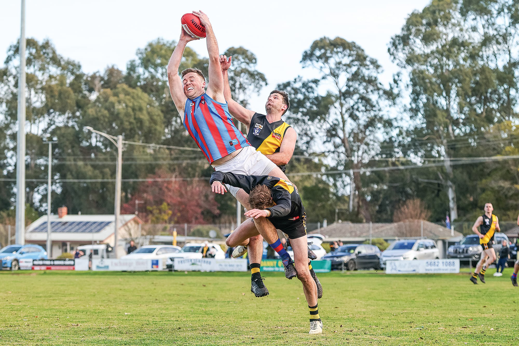 Kieran Bohn takes a flying leap over Foster to ruin the mark. Photo: Bec Casey Sports Photography.