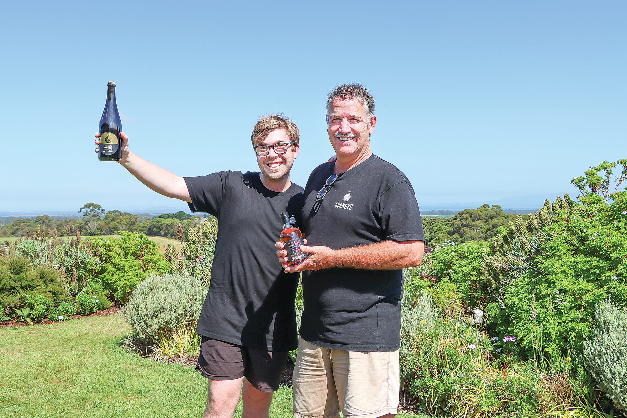James and Bill Gurnett display a couple the products at Gurneys Cider in the garden overlooking Wilsons Promontory. A08_0123