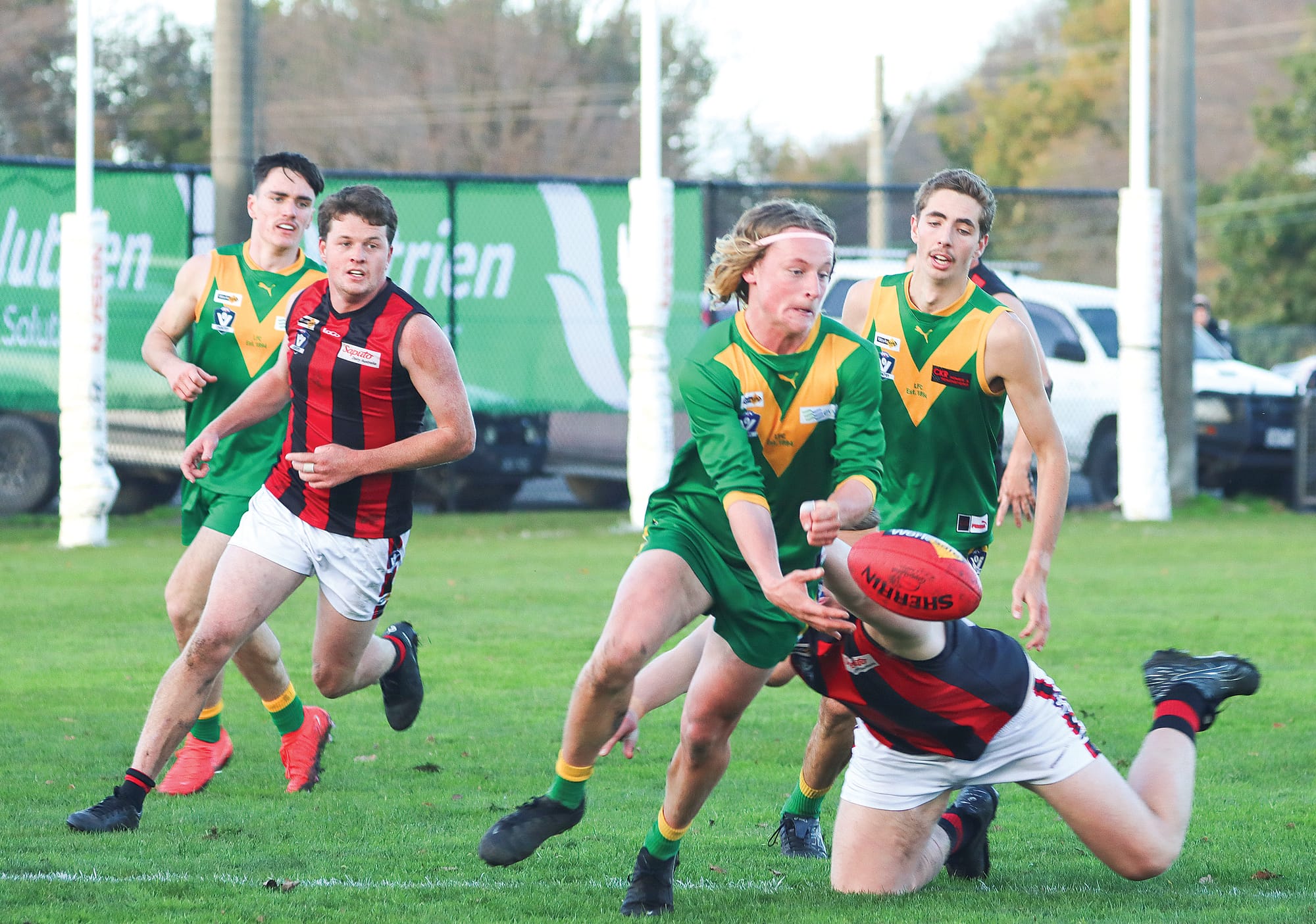 Leongatha’s Ty Hall is pursued by a Maffra opponent as Noah Fixter looks on. A20_2524
