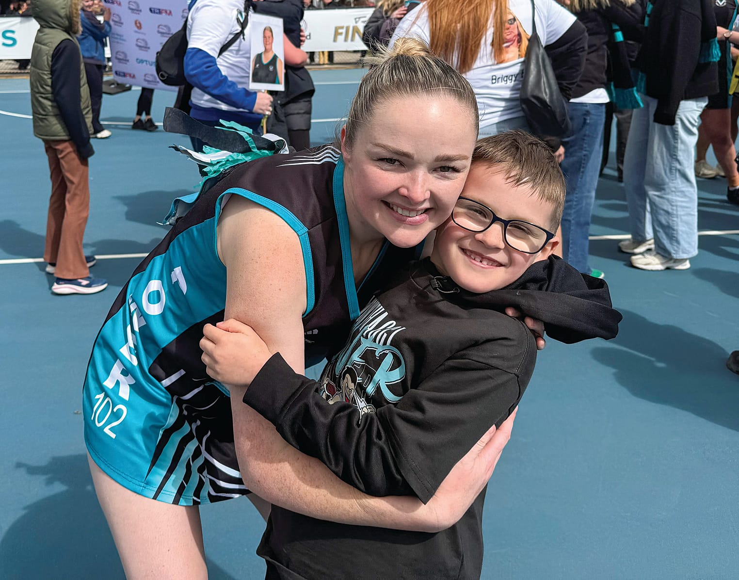 Sam Clarke-Smith celebrates the C Grade premiership win with son Jack after the game.
