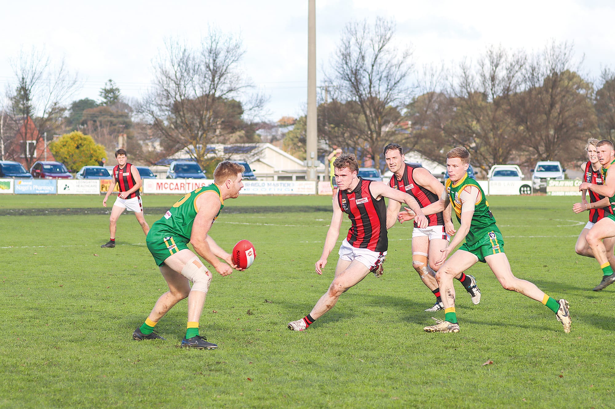 Parrot Matt Borschman shapes to handball during his 100th Senior game. A19_2524