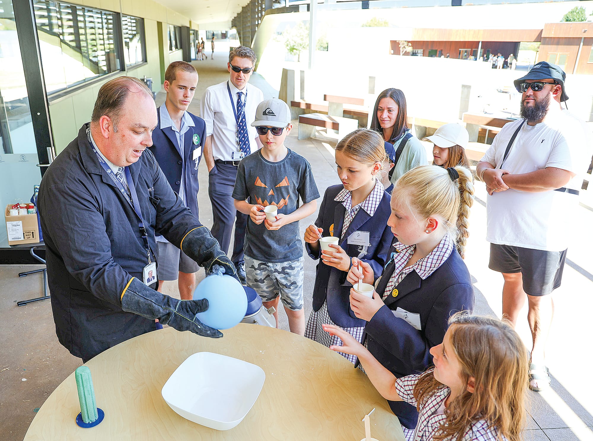 Newhaven College science teacher Brett Torstonsen works his magic for visitors at the college’s open day last Saturday, using dry ice to deflate this balloon and also to make ice cream.