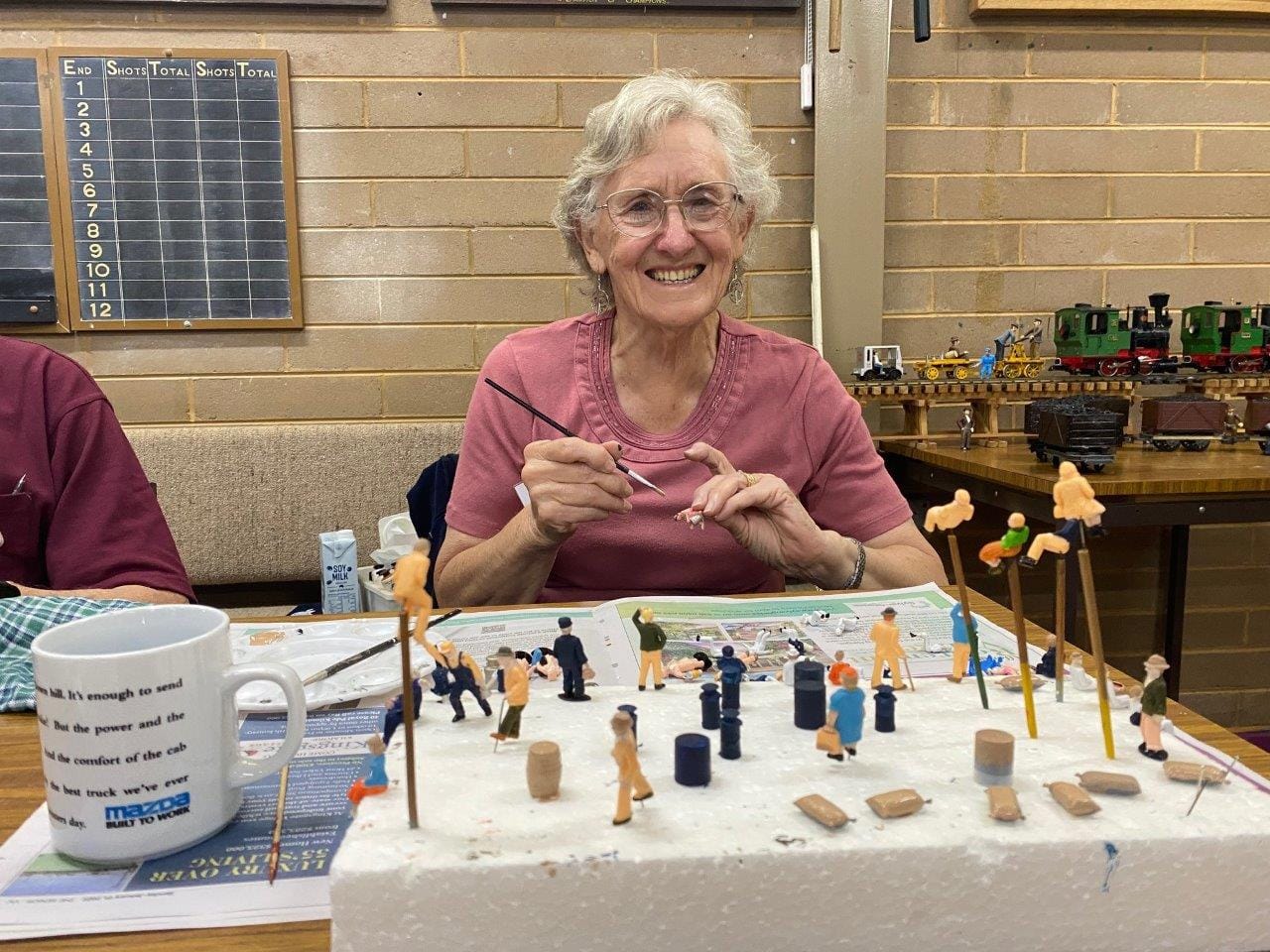 Wendy Sheppard, wife of model train member Jack, demonstrates the intricate work involved in a model railway layout.