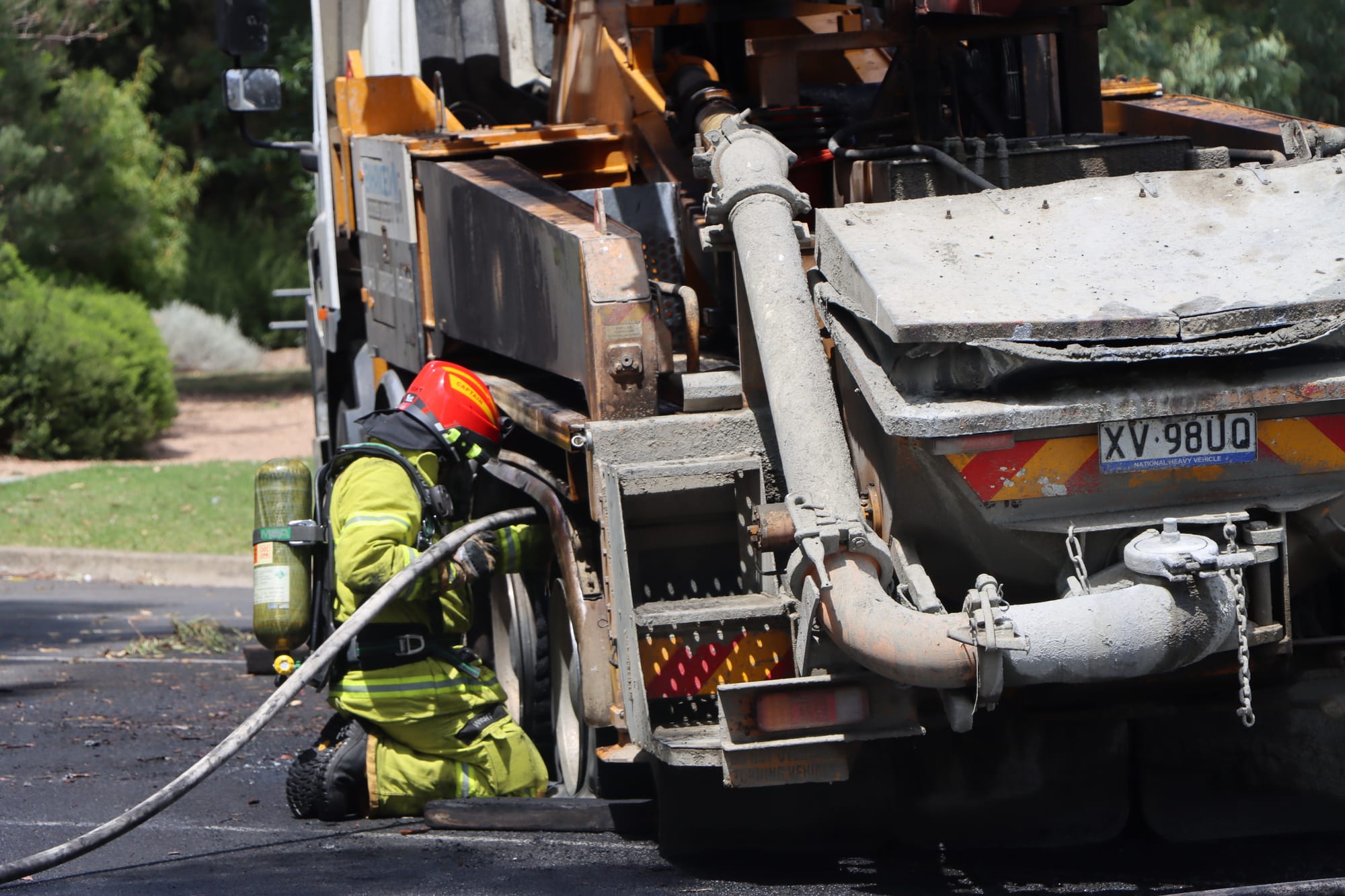 Leongatha Fire Brigade captain Mick Wight works to cool the brake area of the truck to ensure the fire won’t reignite.