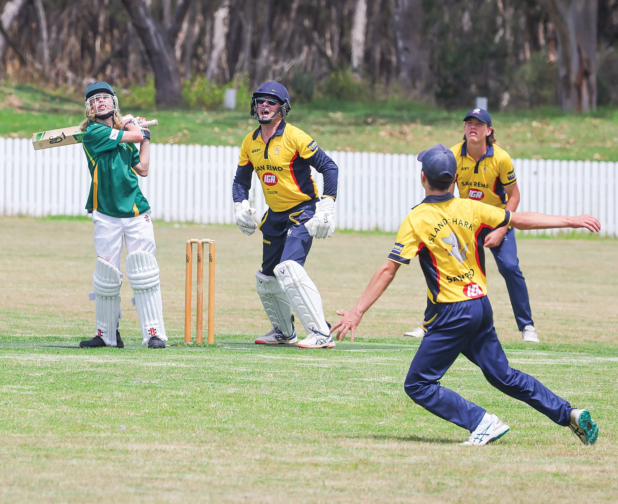Town’s Ethan Smith top edges one off the bowling of Phillip Island’s Peter Francis in the B1 twenty-twenty match at Rhyll on Saturday with Harry Arceob moving to his left to take the high ball.