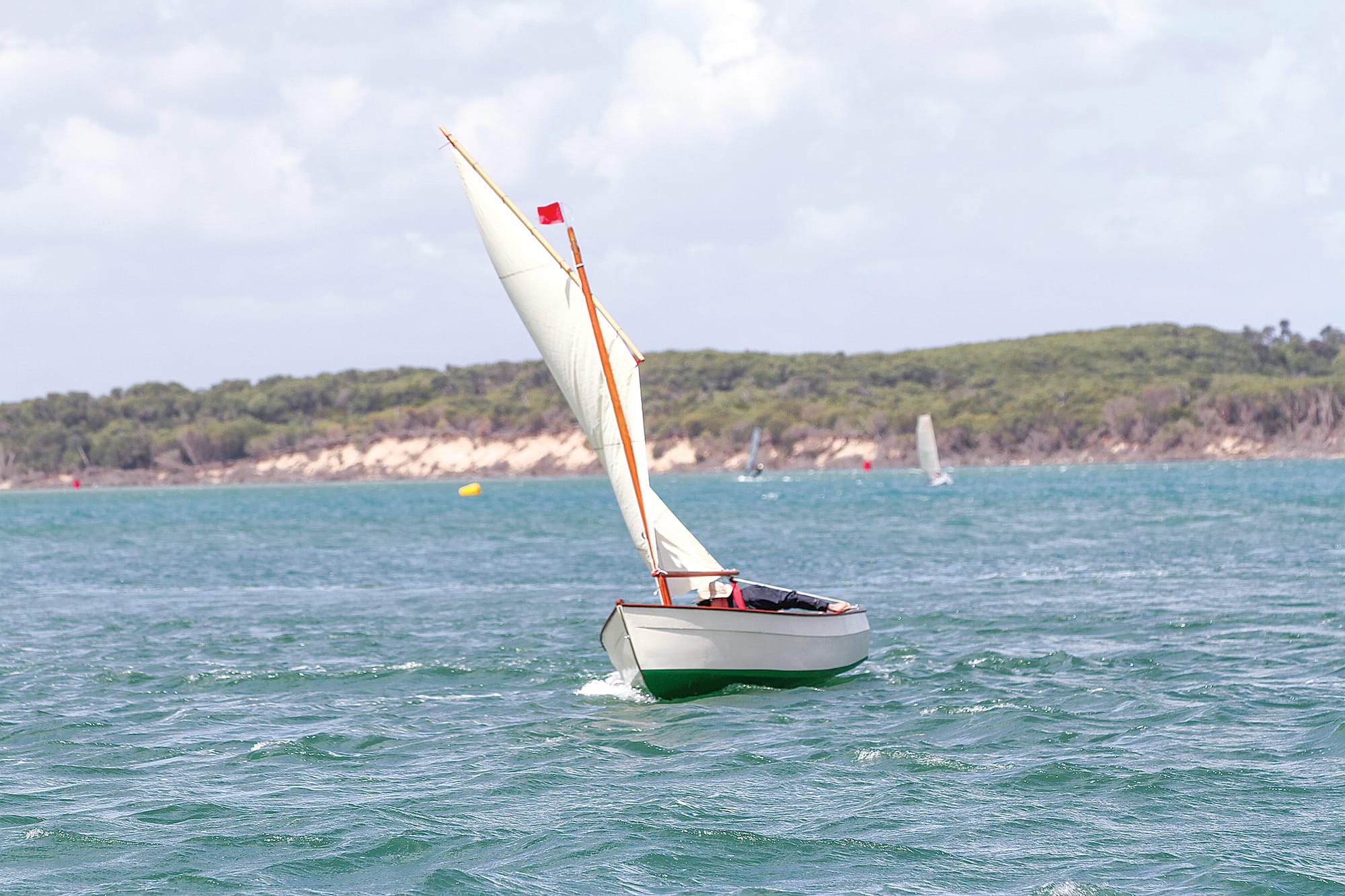 Simon Wilson in a Skerry rounding a deep channel buoy in the Inverloch Wooden Dinghy Classic B76_0725