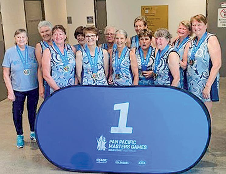 Local netballers Faye Surace of Korumburra and Merran Sice of Wonthaggi celebrate with their Pan Pacific Masters Games gold medals. Photos: ABC Gippsland 
