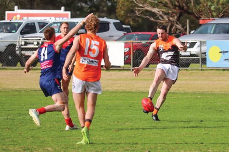 Korumburra-Bena’s Rhys Dixon looks to Tom Crocker in Saturday’s match against Koo Wee Rup.