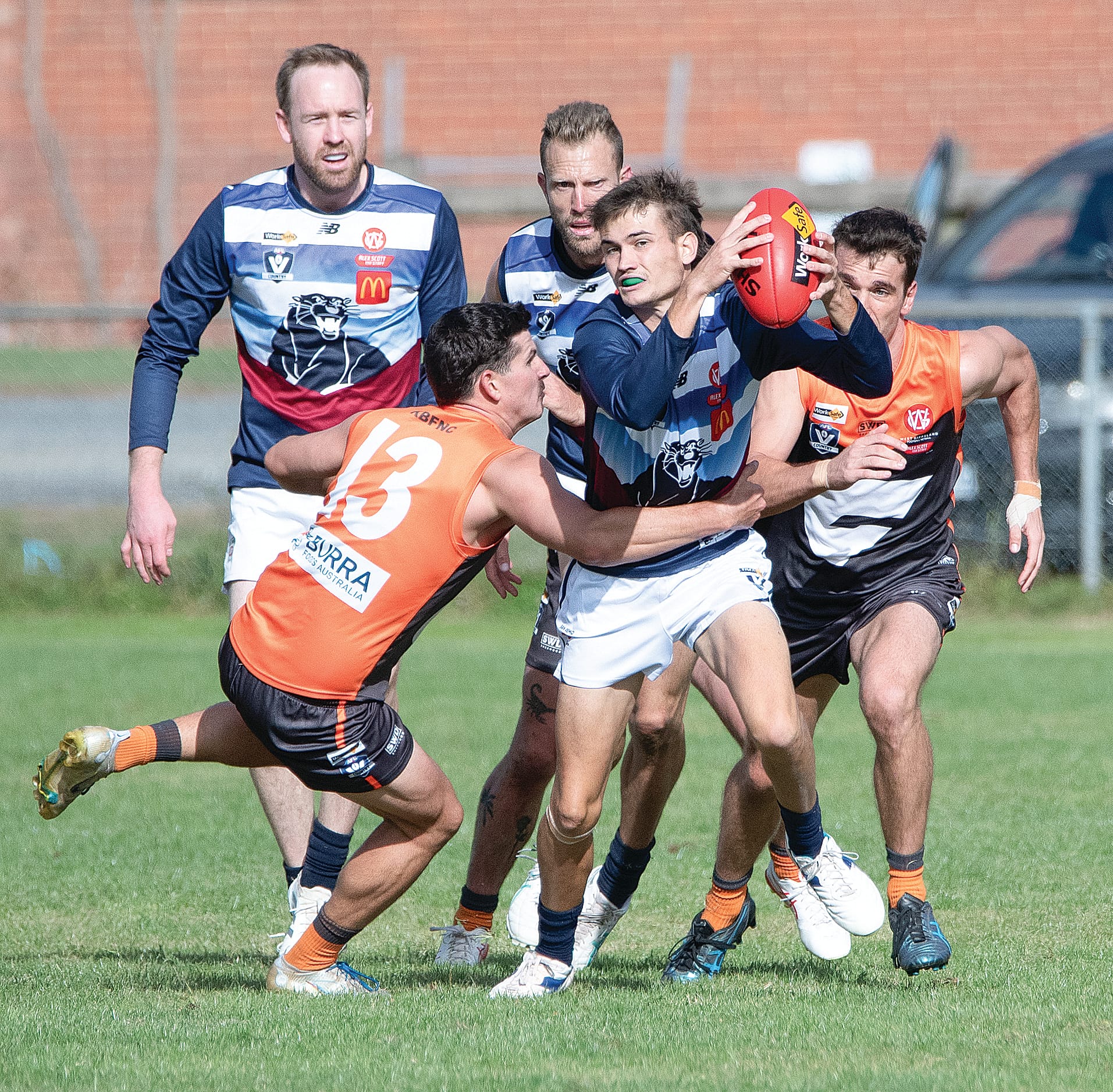 Owen Thomas breaks through the pack in an attempt to move the ball forward for Kilcunda Bass.