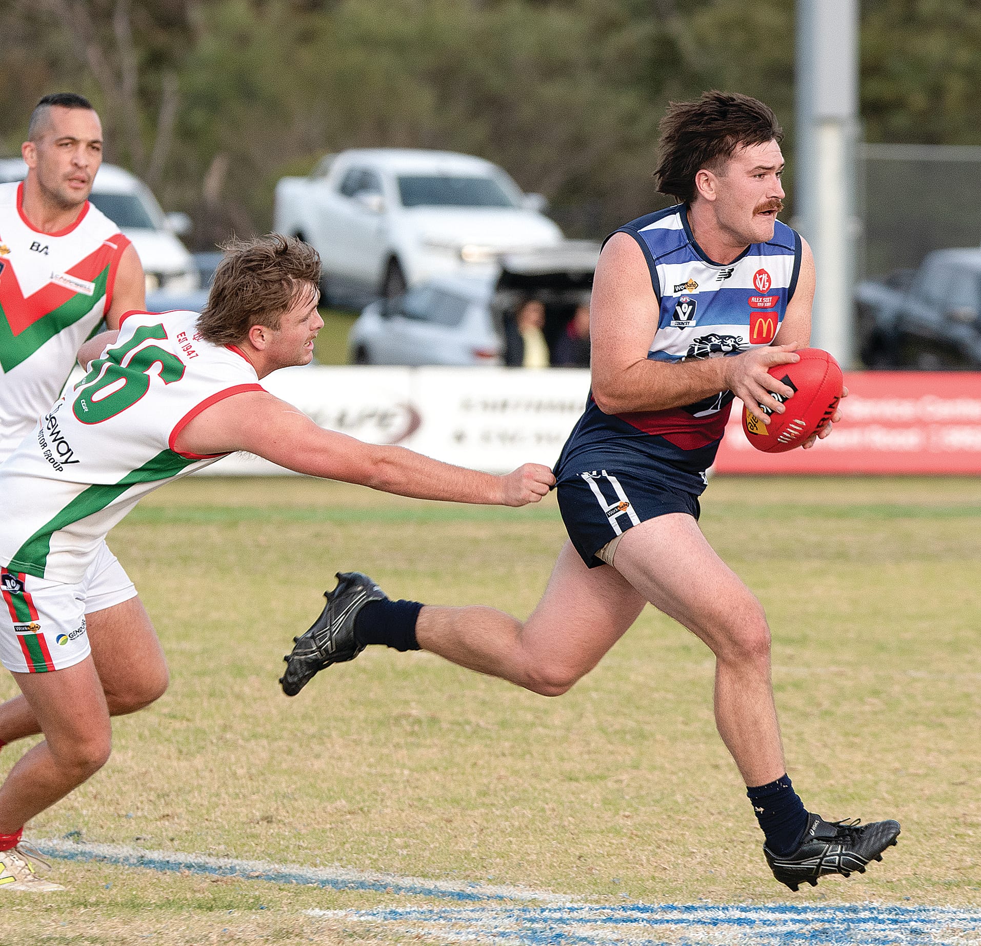 Lachlan Burns slips out of the clutches of his Tooradin-Dalmore opponent.